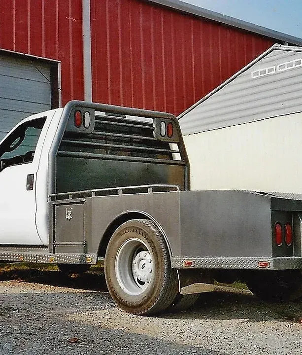 a white truck is parked in front of a red building