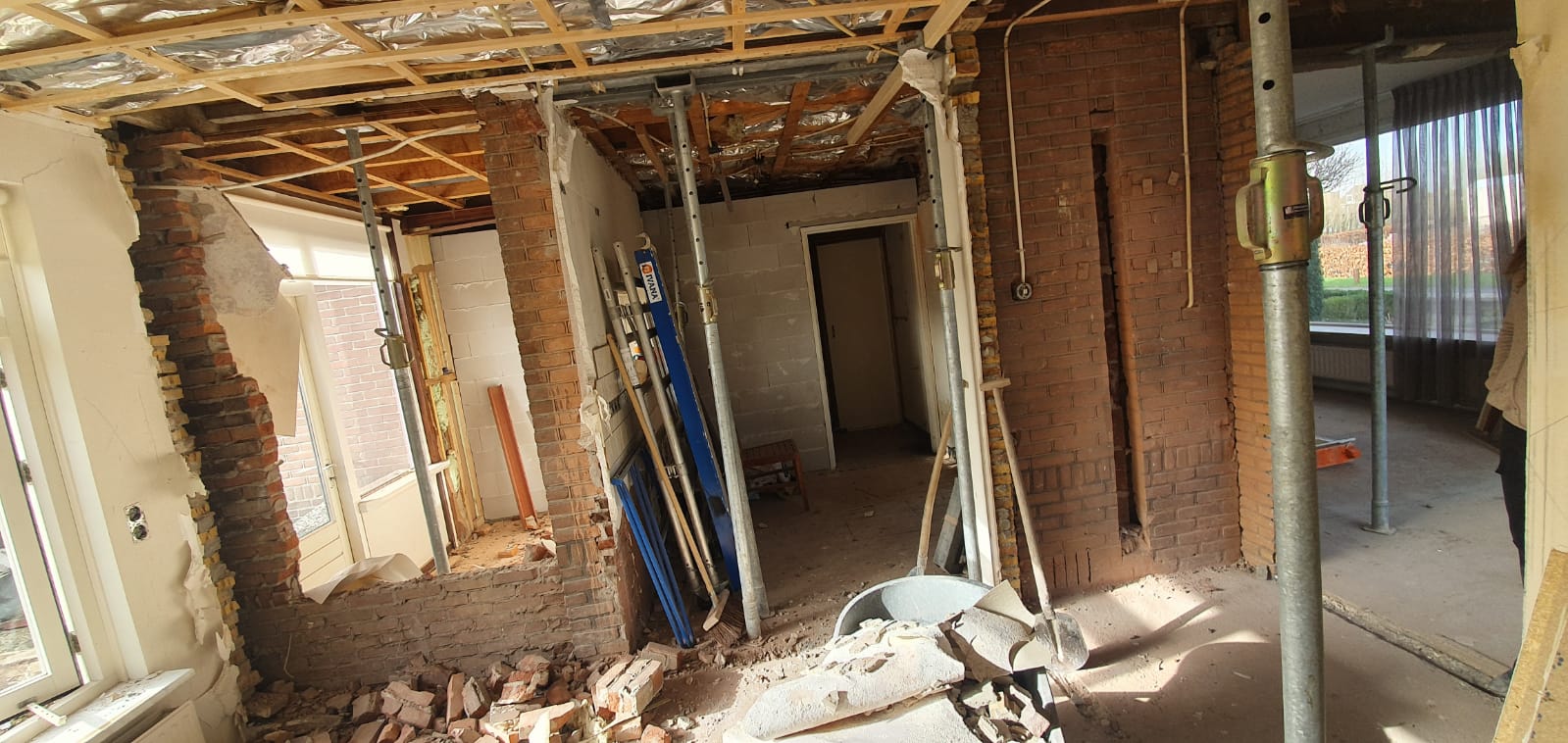 Binnenruimte onder reconstructie met stalen steunpunten. Woningverbouwing en interieur renovatie.