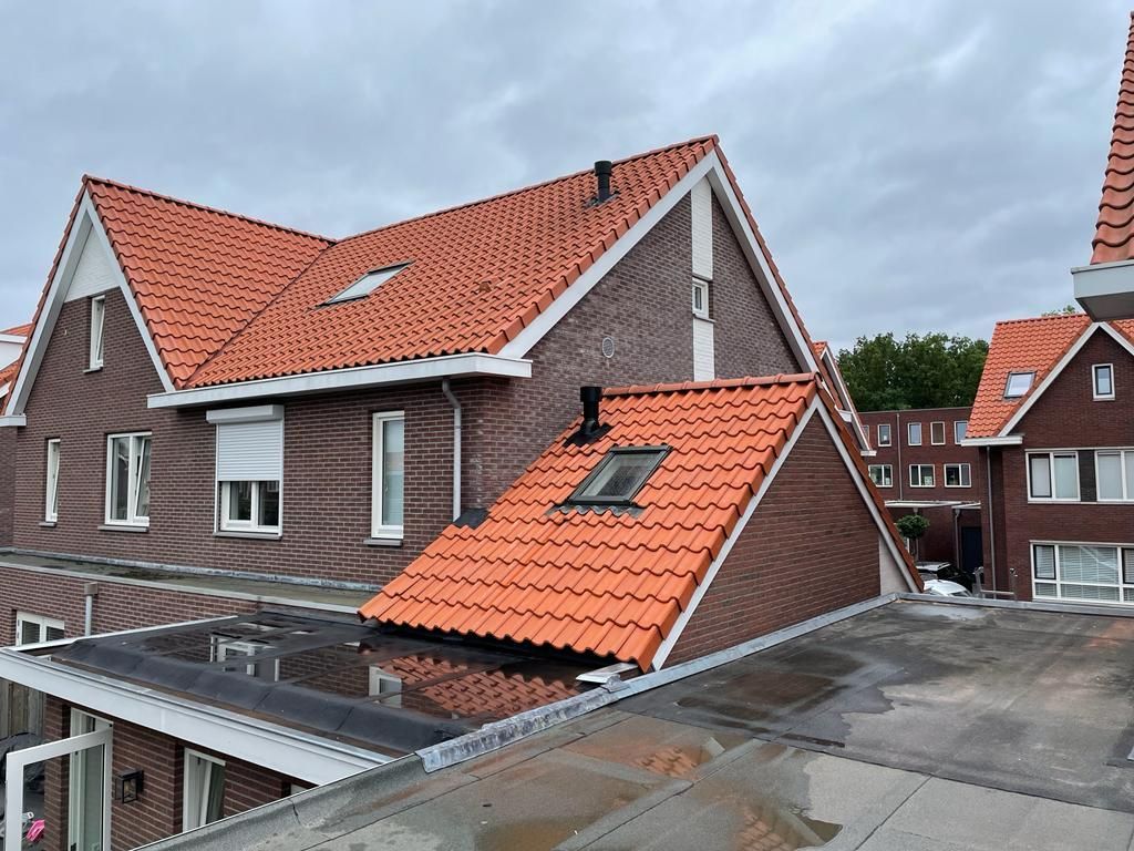 Huis met terracotta pannendak. Aanbouw verbouwing woning.