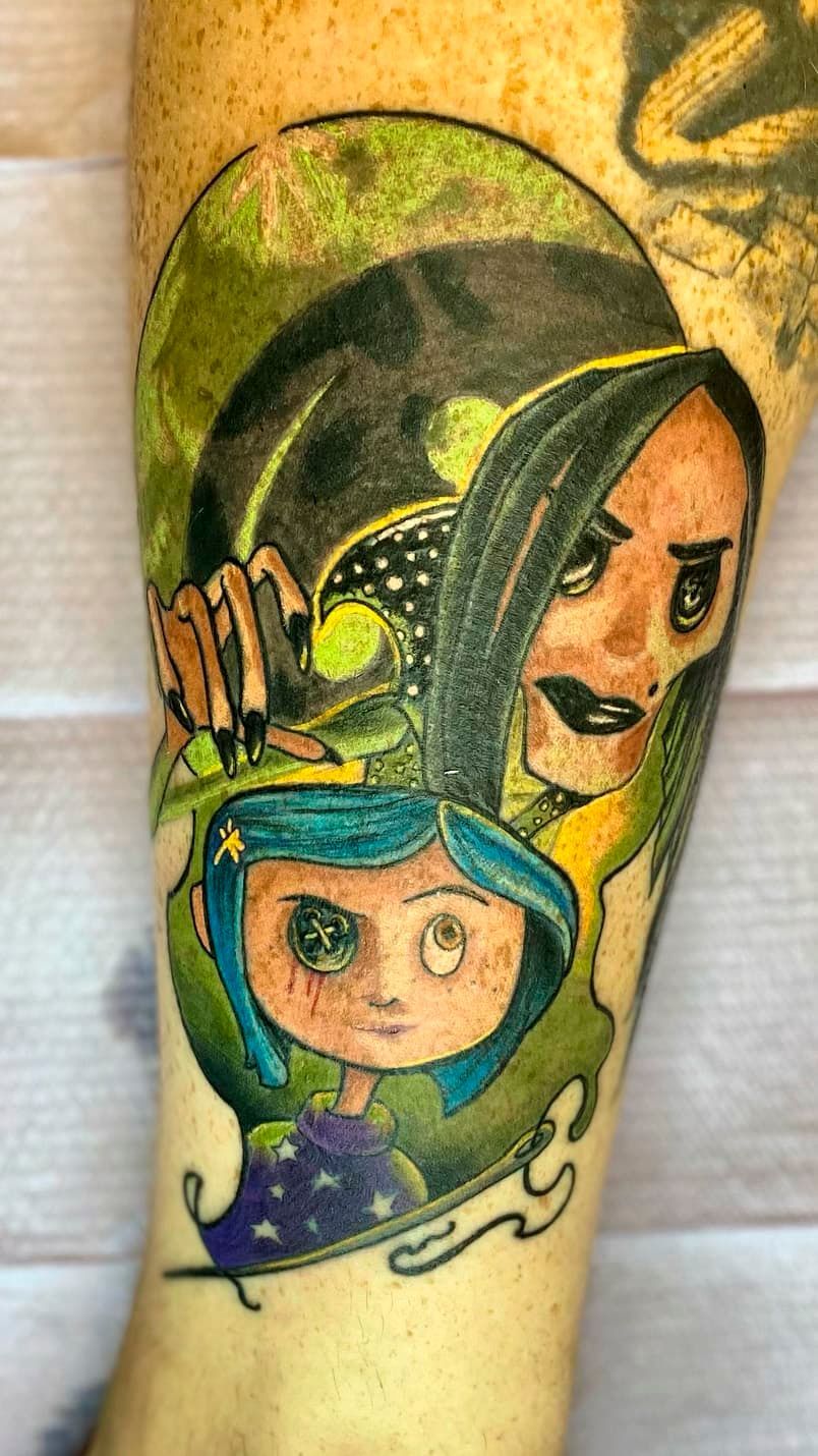 Colorful tattoo of a hooded figure and a smiling child on a forearm
