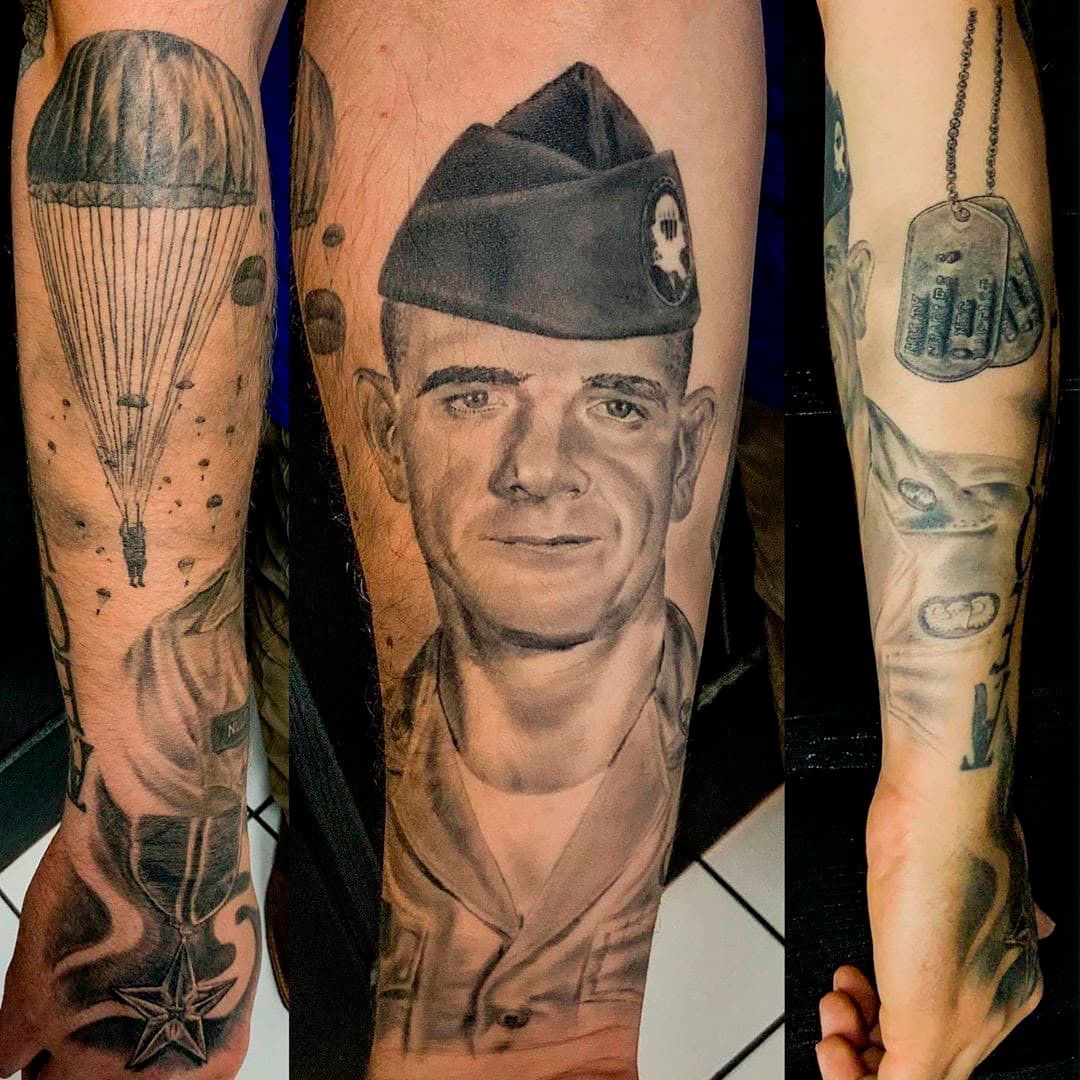 Arm tattoo collage featuring a black-and-gray portrait, military cap, and nautical designs