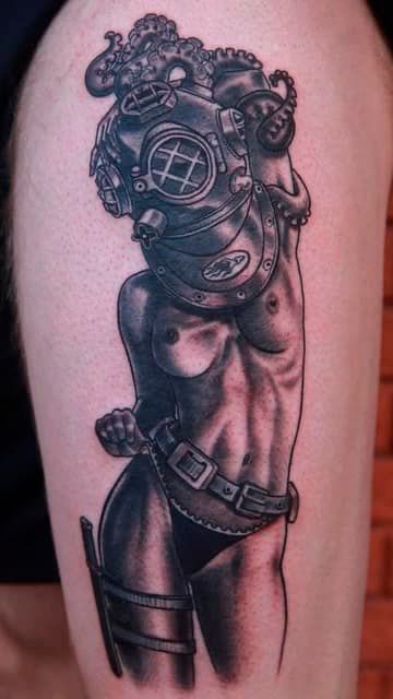 Black-and-gray tattoo of a stylized armored torso with ornate details and a belt on a skin-toned background