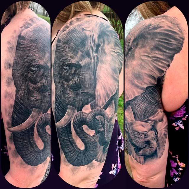 Elephant tattoo on a person’s arm in three side-by-side views, black and gray ink with a heart-shaped trunk detail