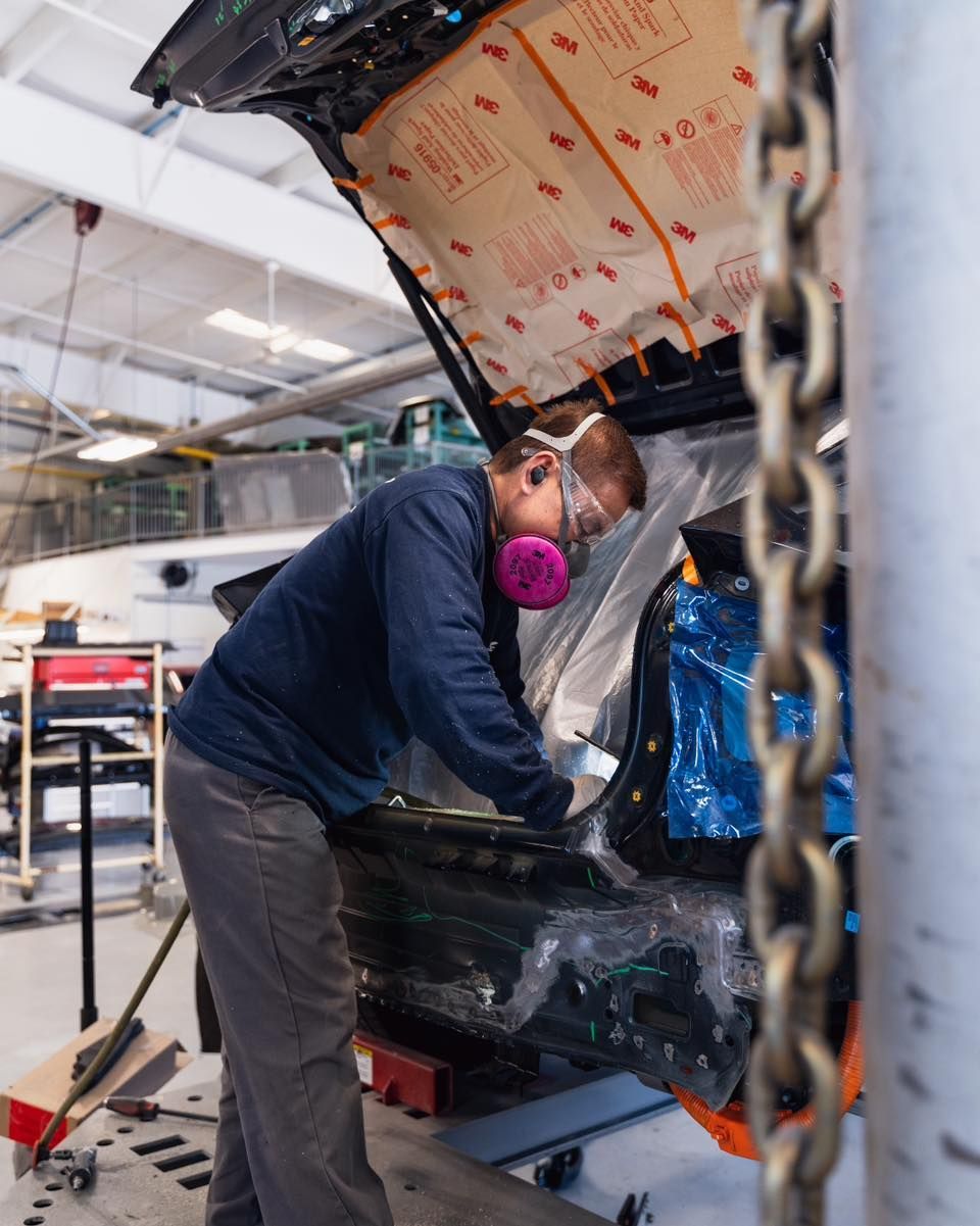 Technician Working Under Car On Hydraulic Lift | D&V Autobody Overland