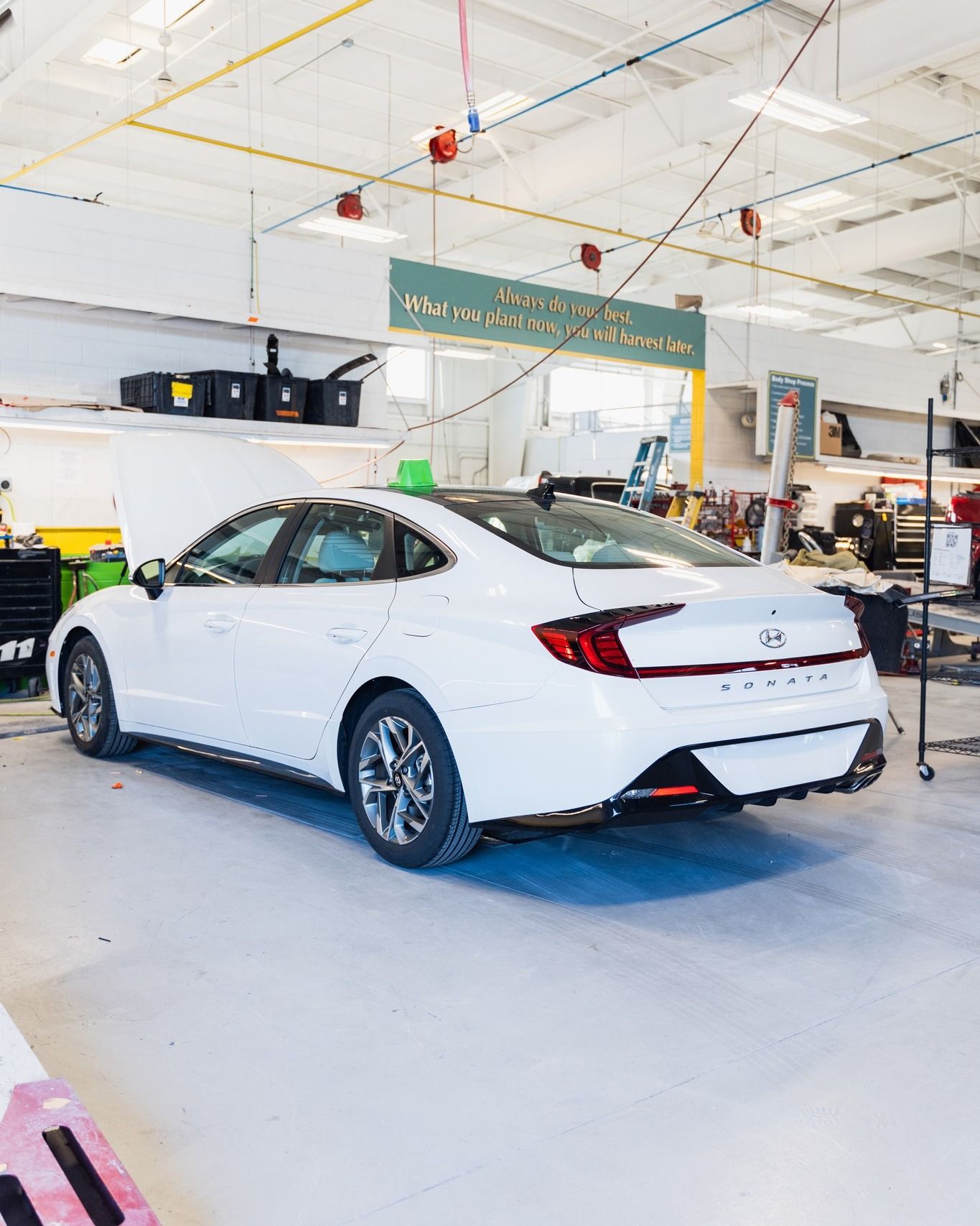 White Sedan Parked Inside Auto Body Facility | D&V Autobody Overland