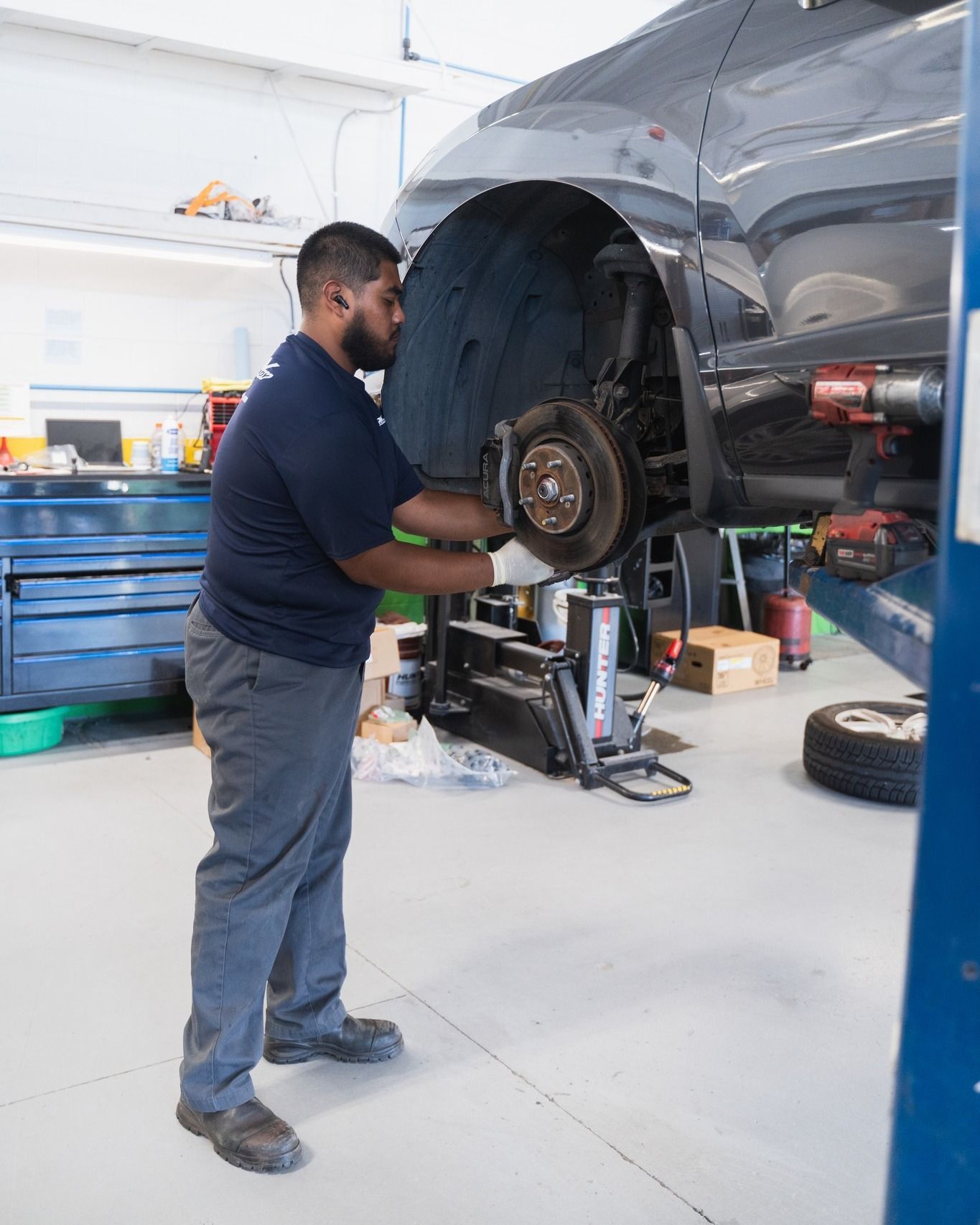 Mechanic Repairing Brake System Of Vehicle | D&V Autobody Overland