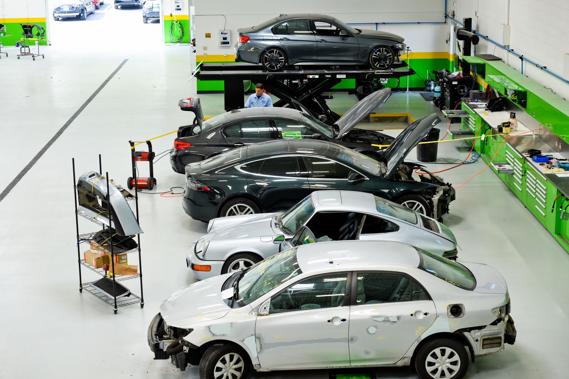 White Car Under Repair In Shop Bay | D&V Autobody