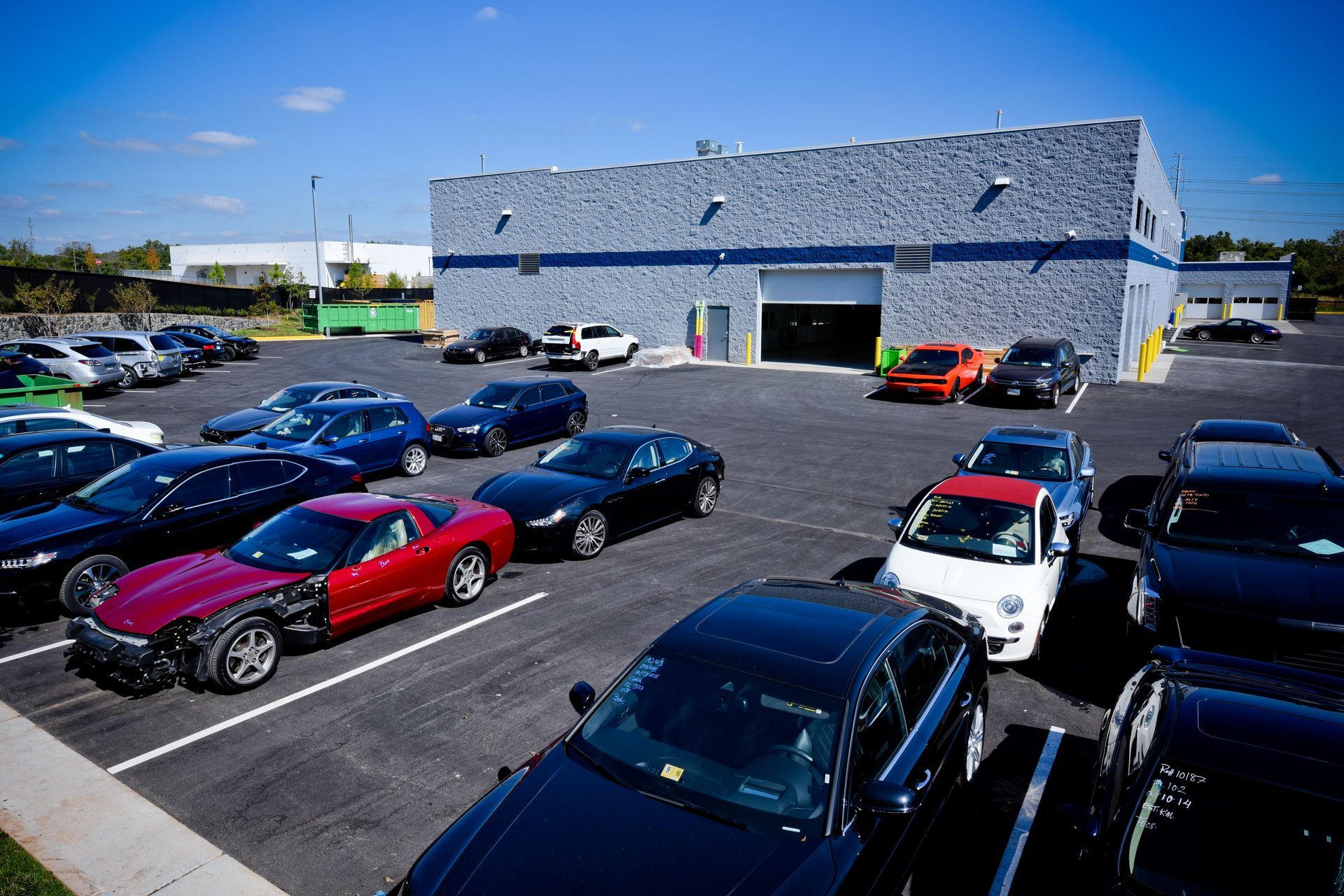 Multiple Vehicles Parked Outside Facility Building | D&V Autobody
