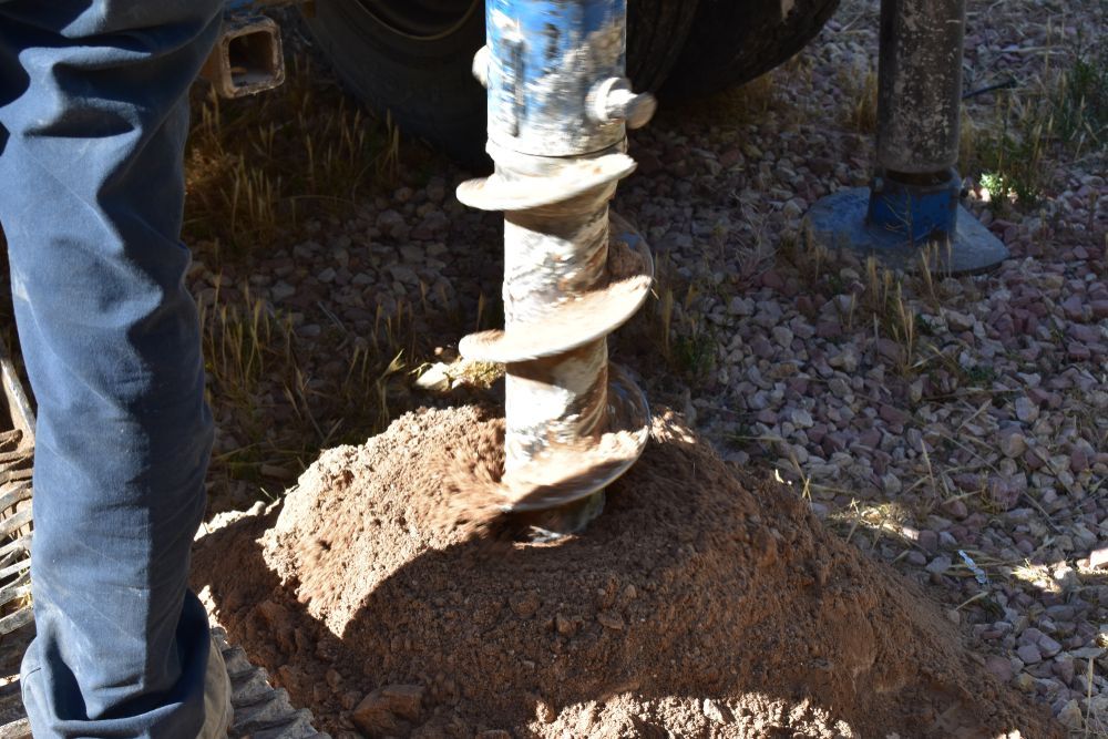 Blue Auger Drilling Into Brown Earth — Allquip Rentals Pty Ltd in Cooroy, QLD