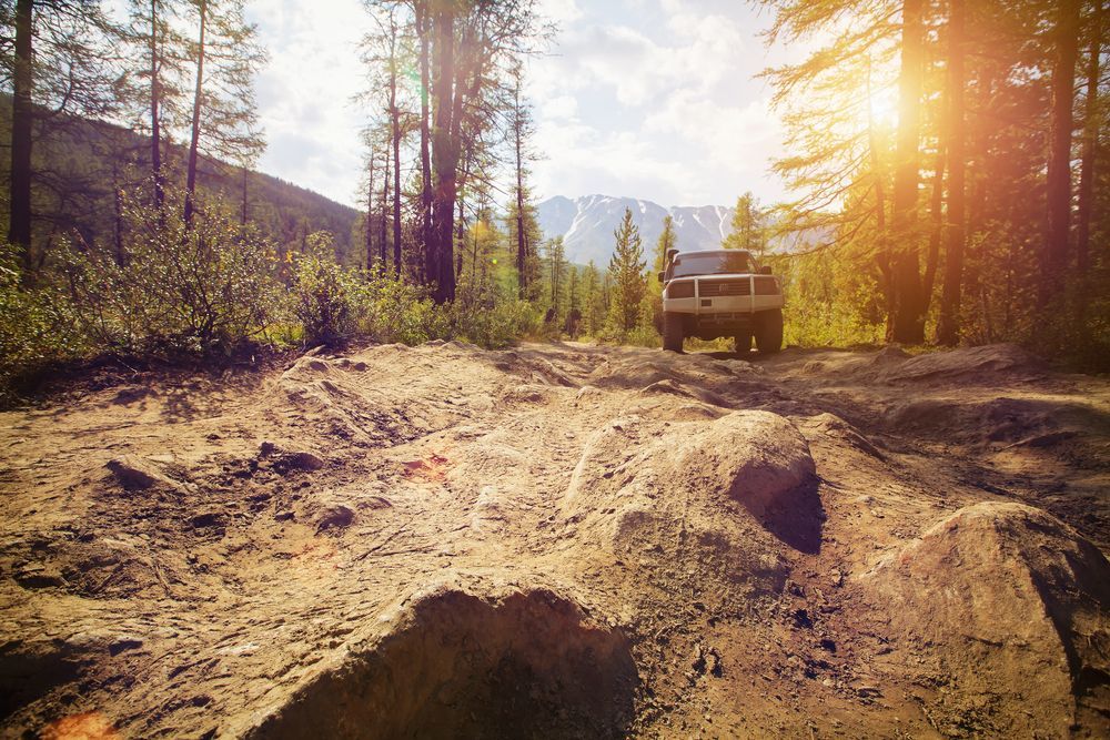 Off-road Vehicle Driving on a Rugged Dirt Road — Allquip Rentals Pty Ltd in Cooroy, QLD