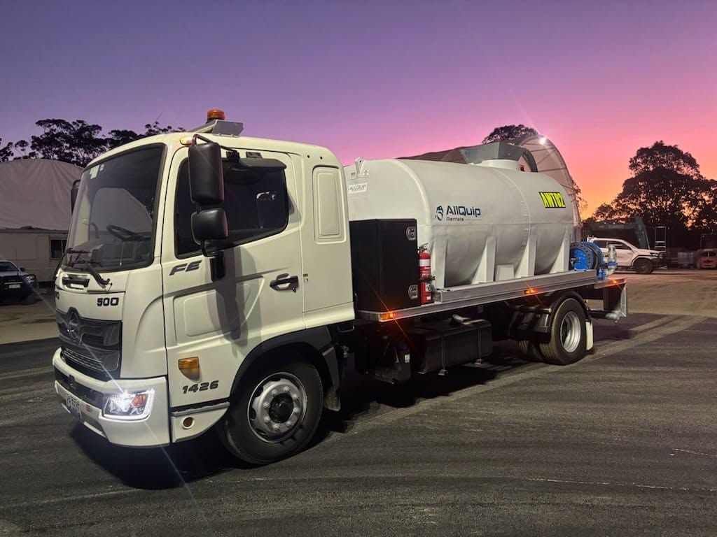 White Water Truck Parked at Dusk Under a Pink-purple Sky — Allquip Rentals Pty Ltd in Cooroy, QLD