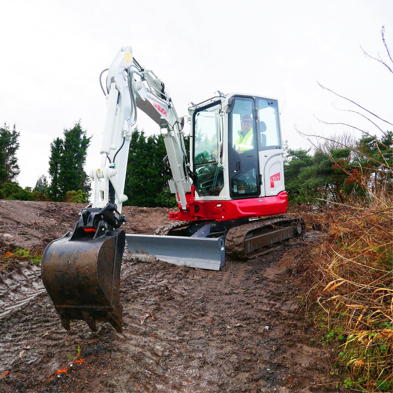 A Small Red and White Excavator on a Muddy Path — Allquip Rentals Pty Ltd in Cooroy, QLD