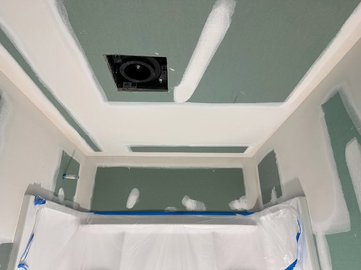 A room with a ceiling that is being painted