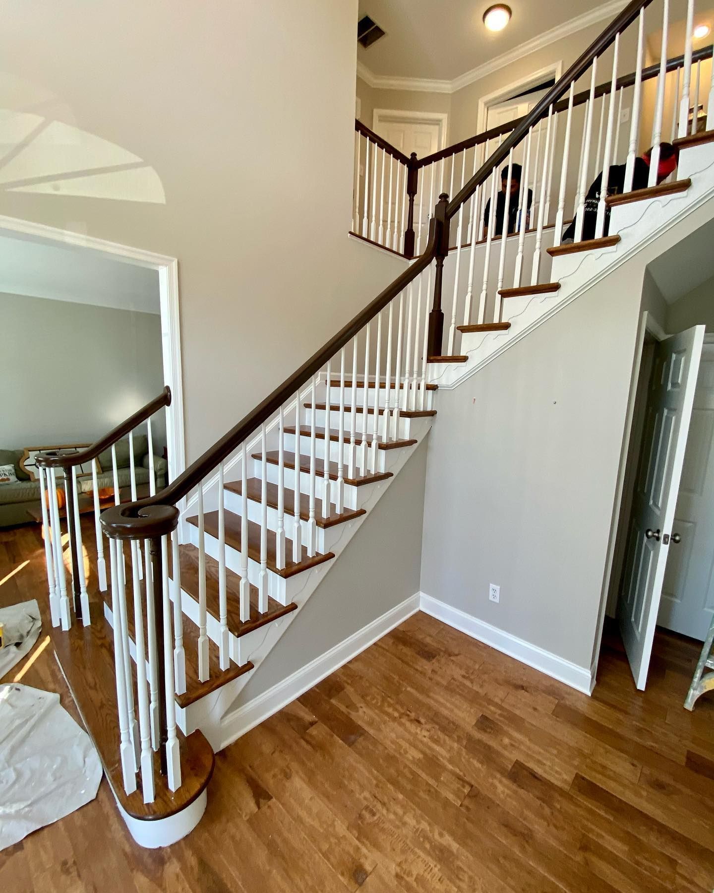 A staircase in a house with wooden steps and a white railing.