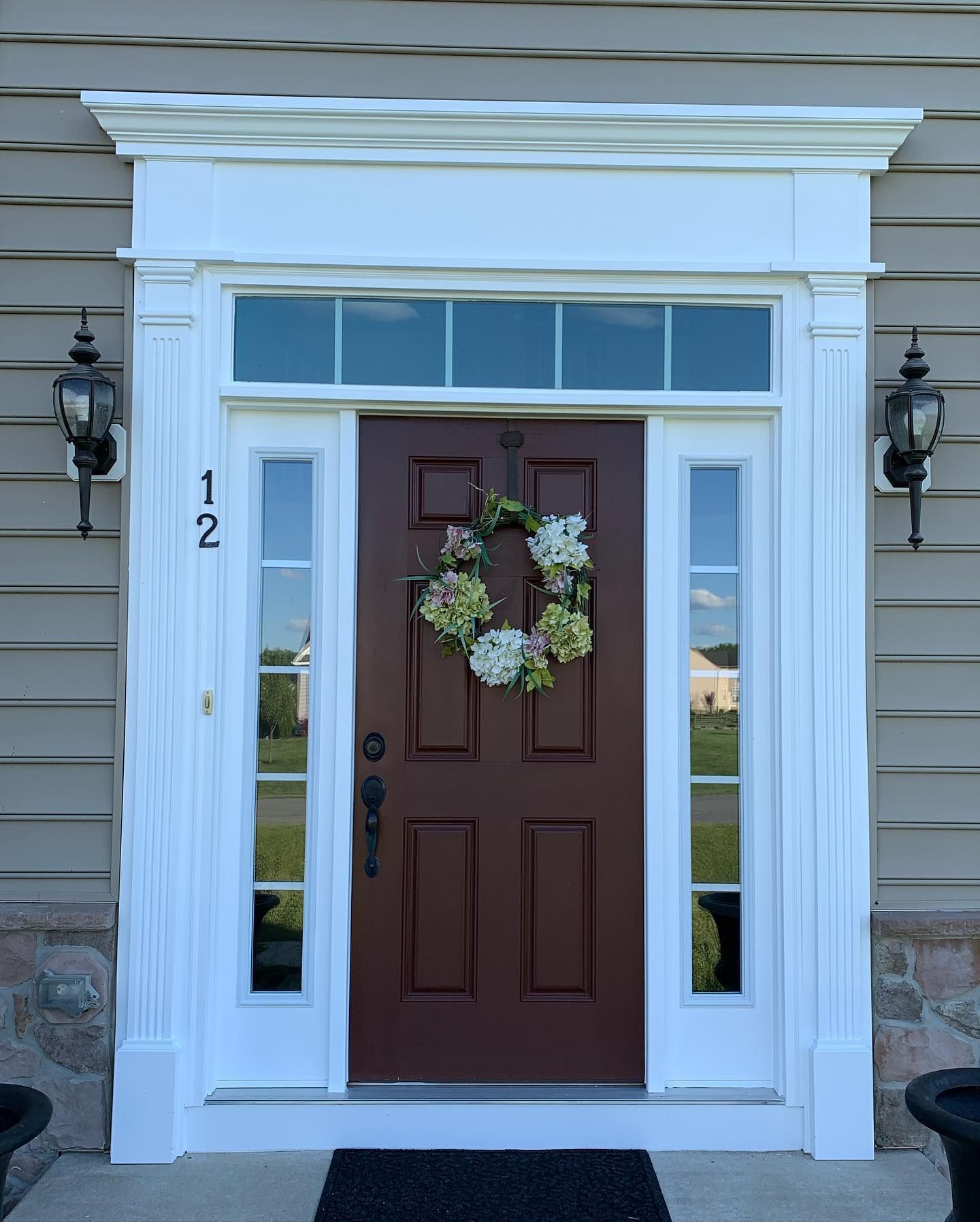 The front door of a house has the number 12 on it
