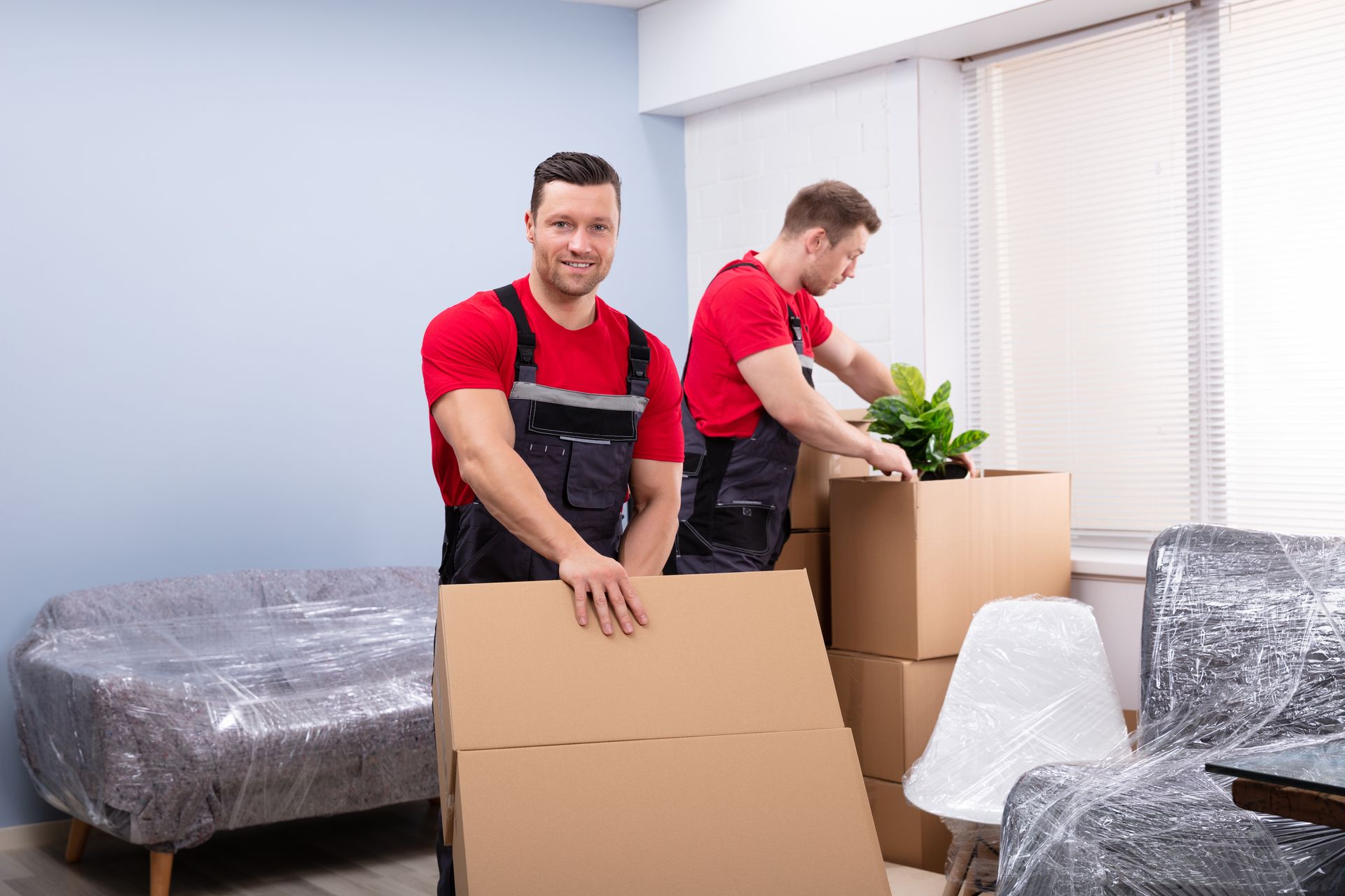 Movers Holding Boxes — Los Angeles, CA — Walters Transfer & Moving Movers Holding Boxes — Los Angeles, CA — Walters Transfer & Moving