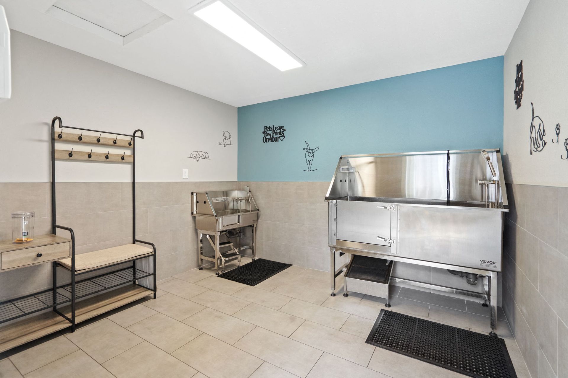 Community pet washing station with stainless steel tub, bench, and hooks at The Reserve at Capital Center.