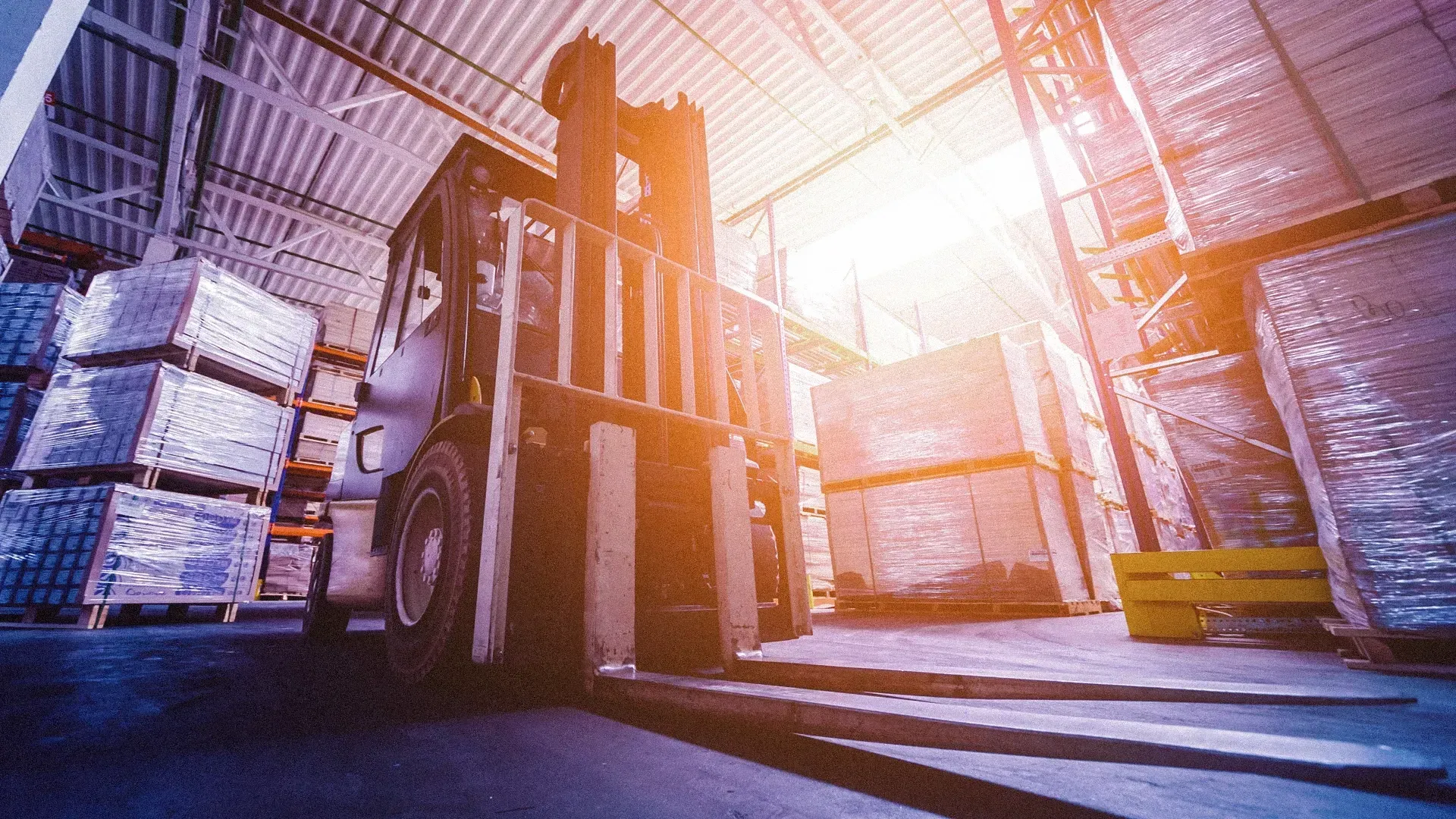 A forklift is moving boxes in a warehouse.