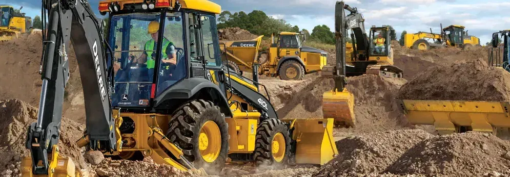 A group of construction vehicles are working on a construction site.