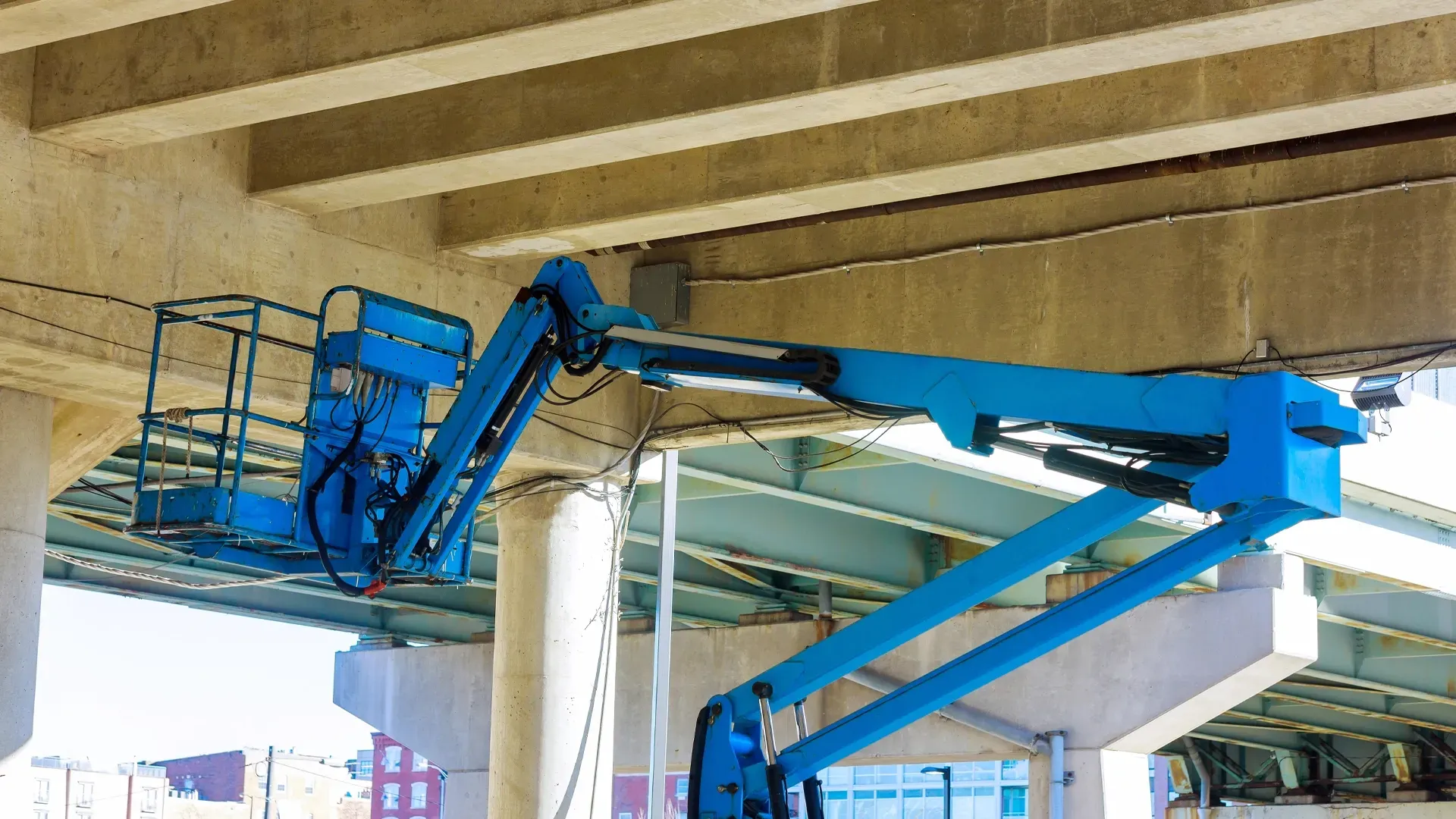 Electric scissor lifts and boom lifts from JM Development on active construction sites.