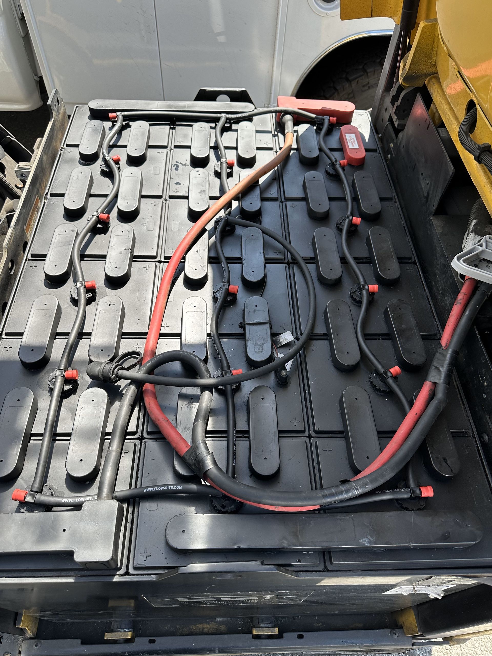 A bunch of batteries are sitting on top of a vehicle.
