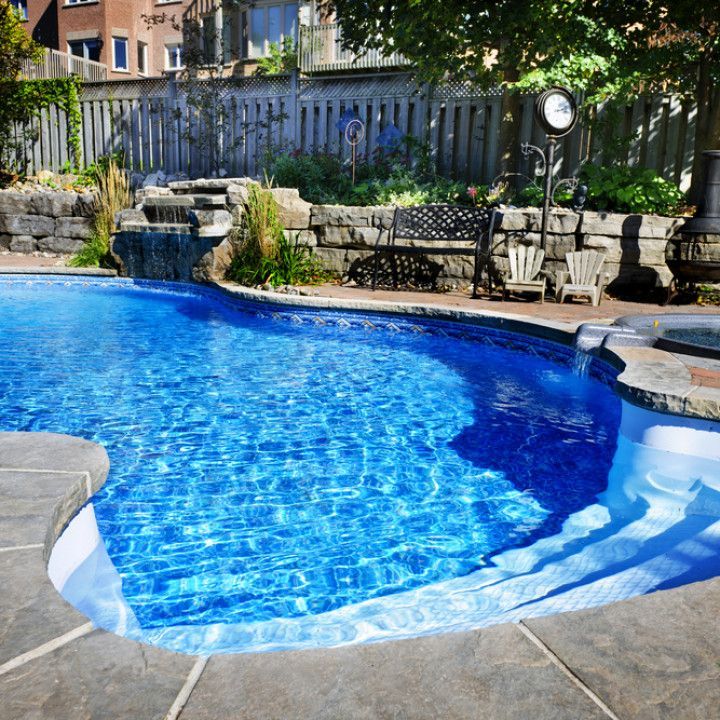 A large blue swimming pool in a backyard