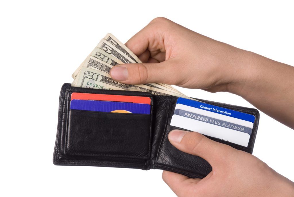 A person is taking money out of their wallet A person is taking money out of their wallet