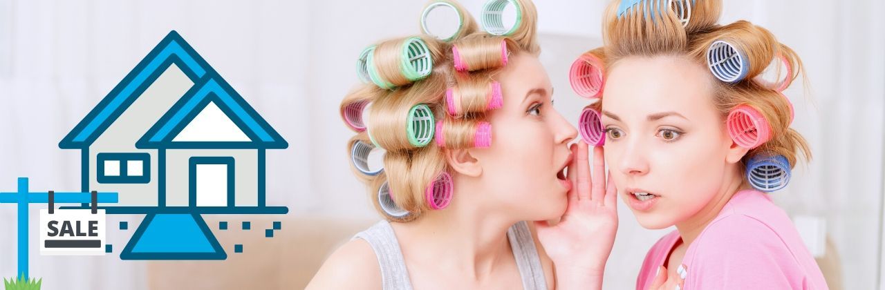 Two women with curlers in their hair; one whispers to the surprised other.