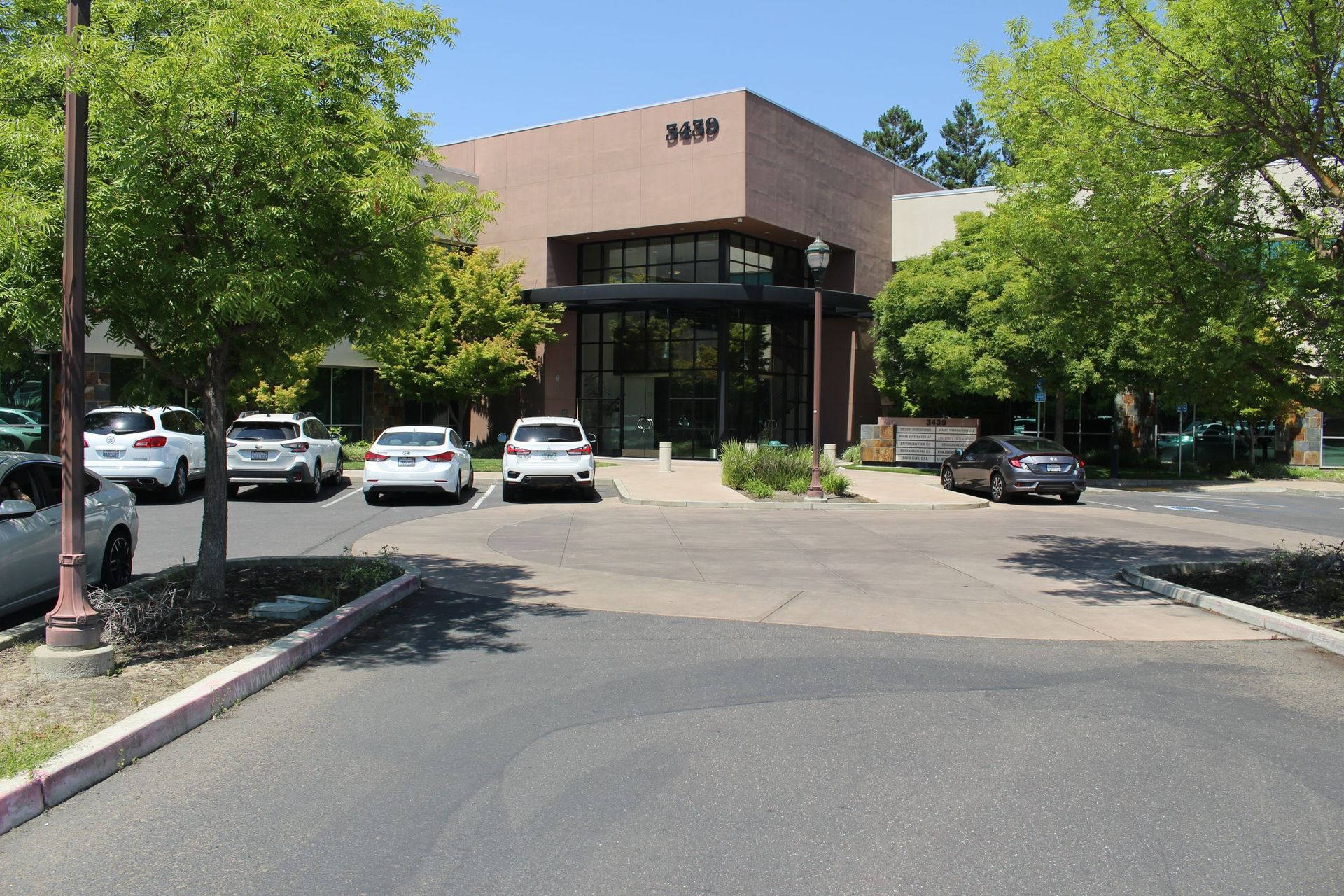 A parking lot with cars parked in front of a building | Mortgage Companies in Roseville, CA