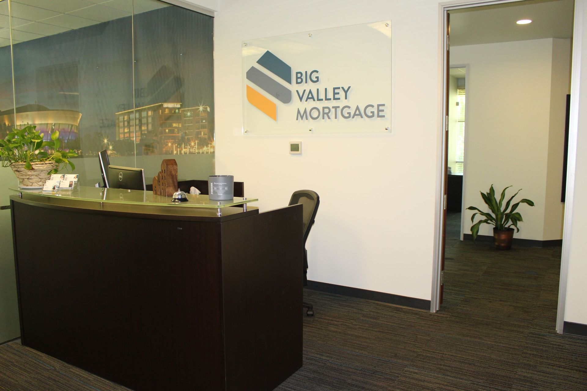 A Big Valley Mortgage sign hangs above a desk | Mortgage Company in Roseville, CA