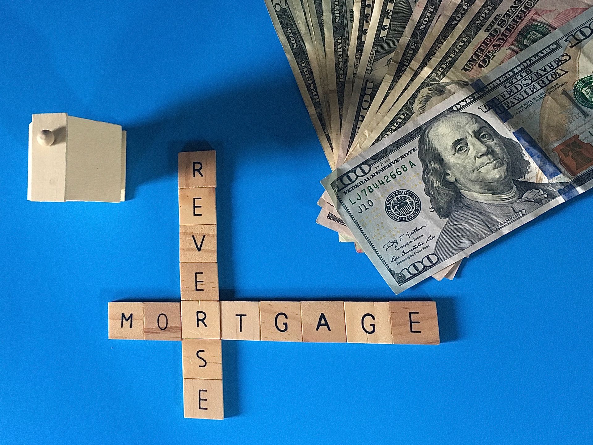 House, cash, and word blocks spelling 