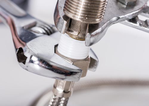 Adjusting Fittings Using Wrench — Plumbing Services in Bathurst, NSW