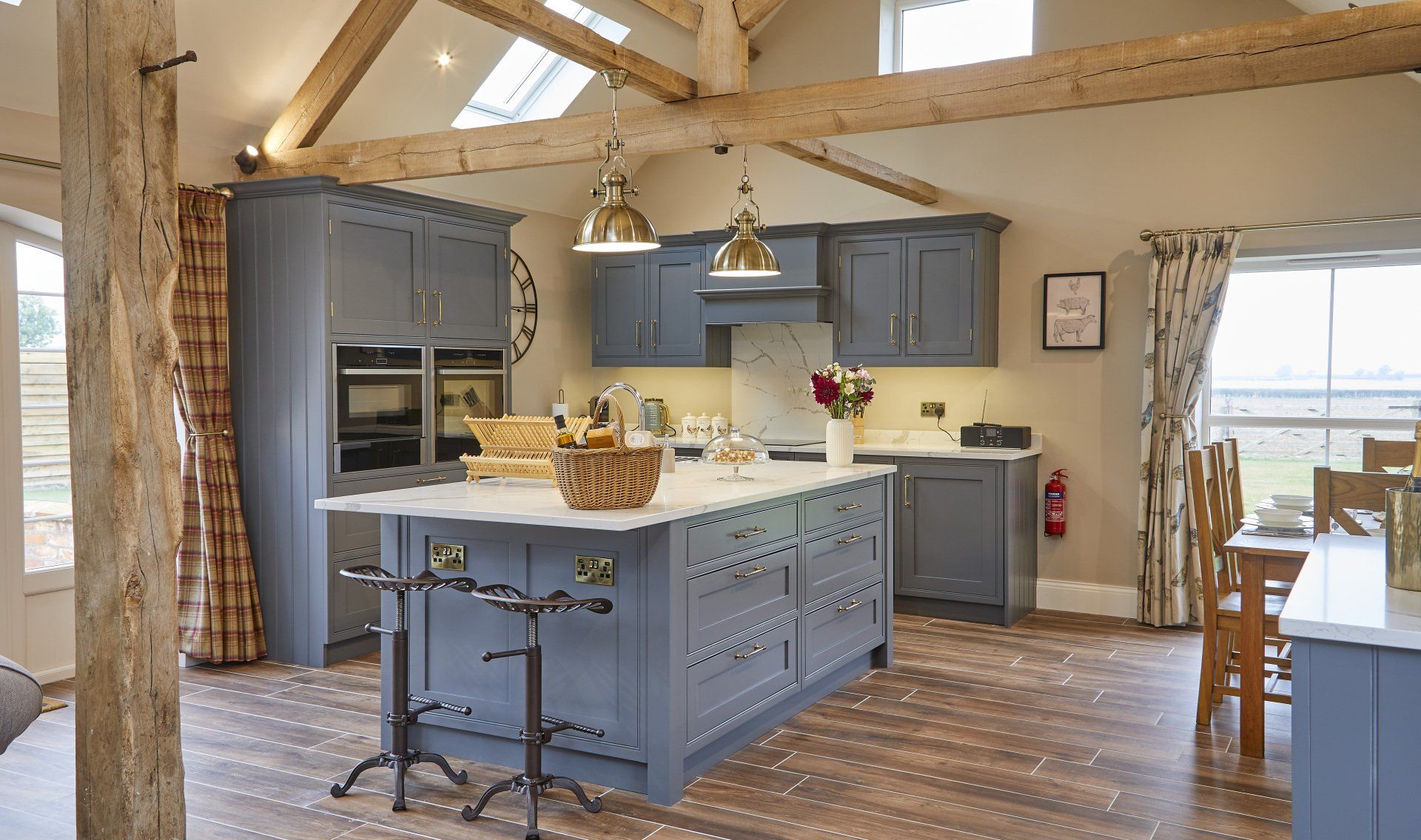 A kitchen with blue cabinets and a large island in the middle.