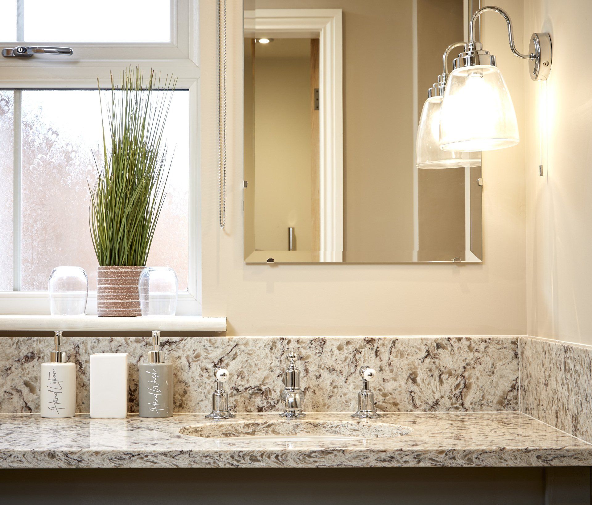 A bathroom with a sink and a mirror