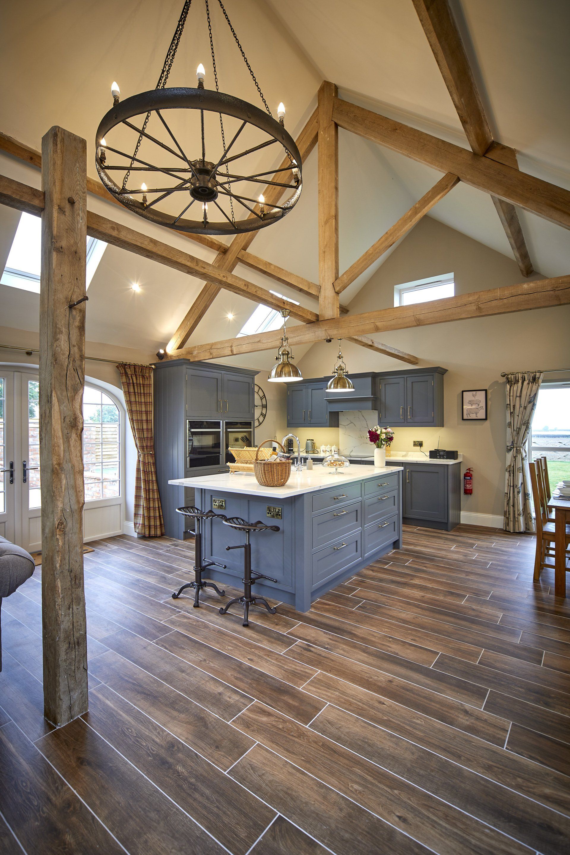 A kitchen with a large island and a chandelier hanging from the ceiling.