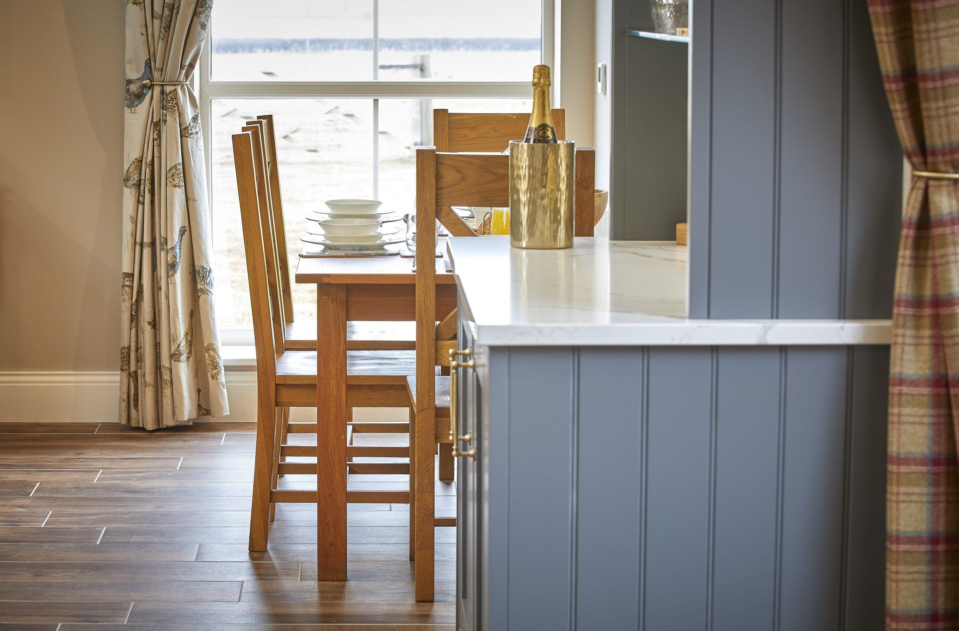 A kitchen with a table and chairs and a window