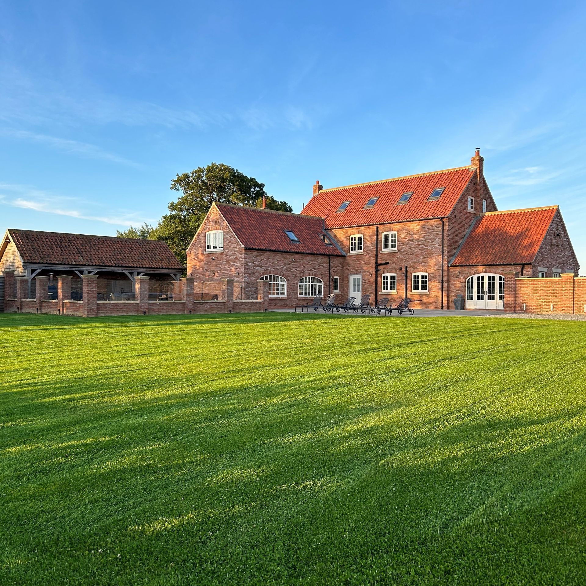 large enclosed garden with lawned area for children to safely run around and burn off some energy whilst the parents and grandparents relax