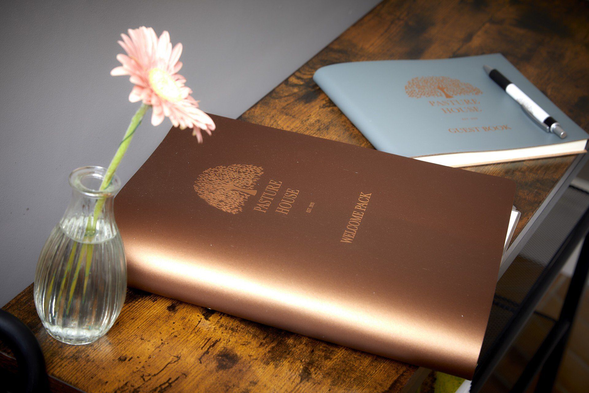 A book with a flower in a vase on top of it