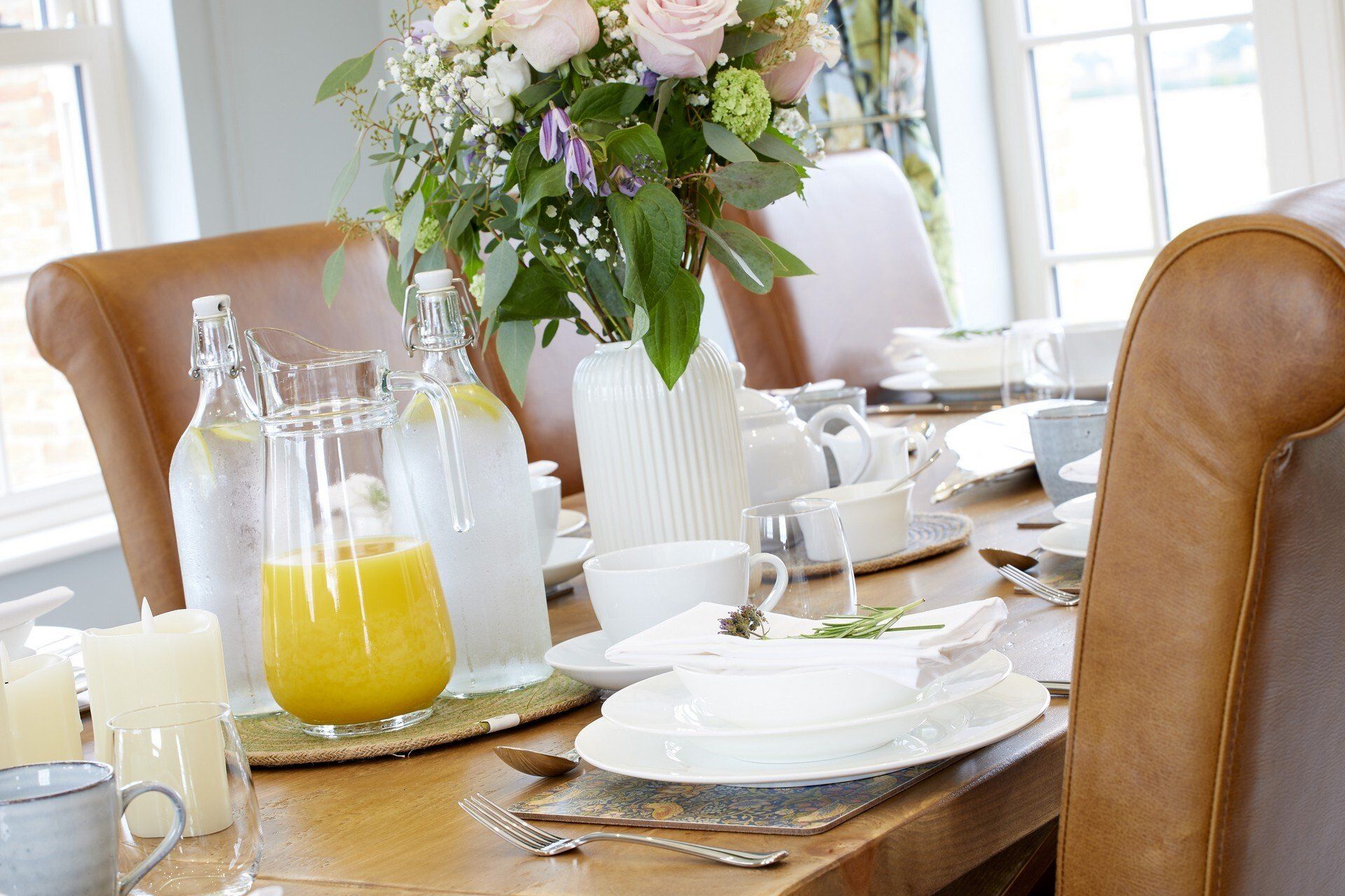There is a vase of flowers on the table in the dining room.