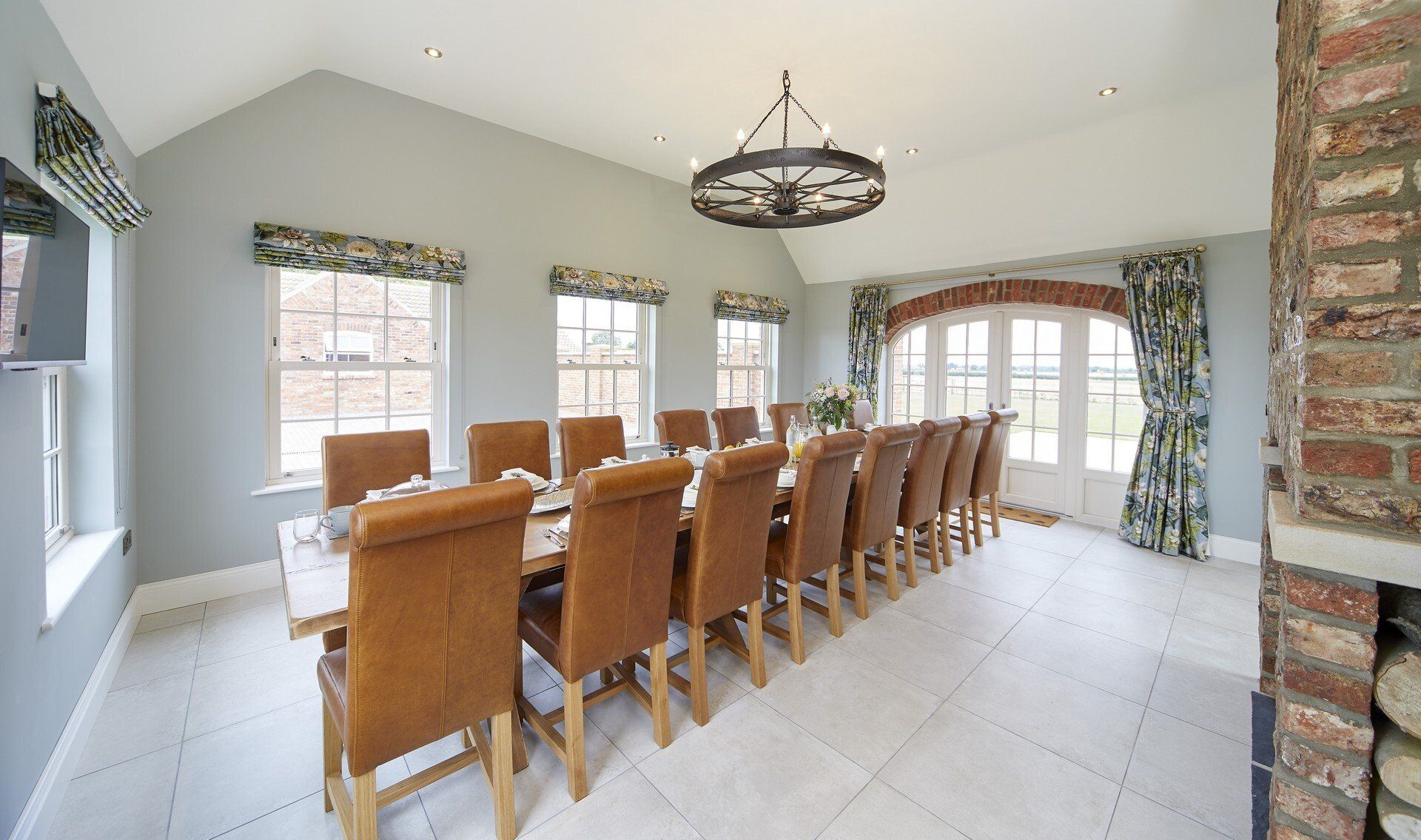 A large dining room with a long table and chairs