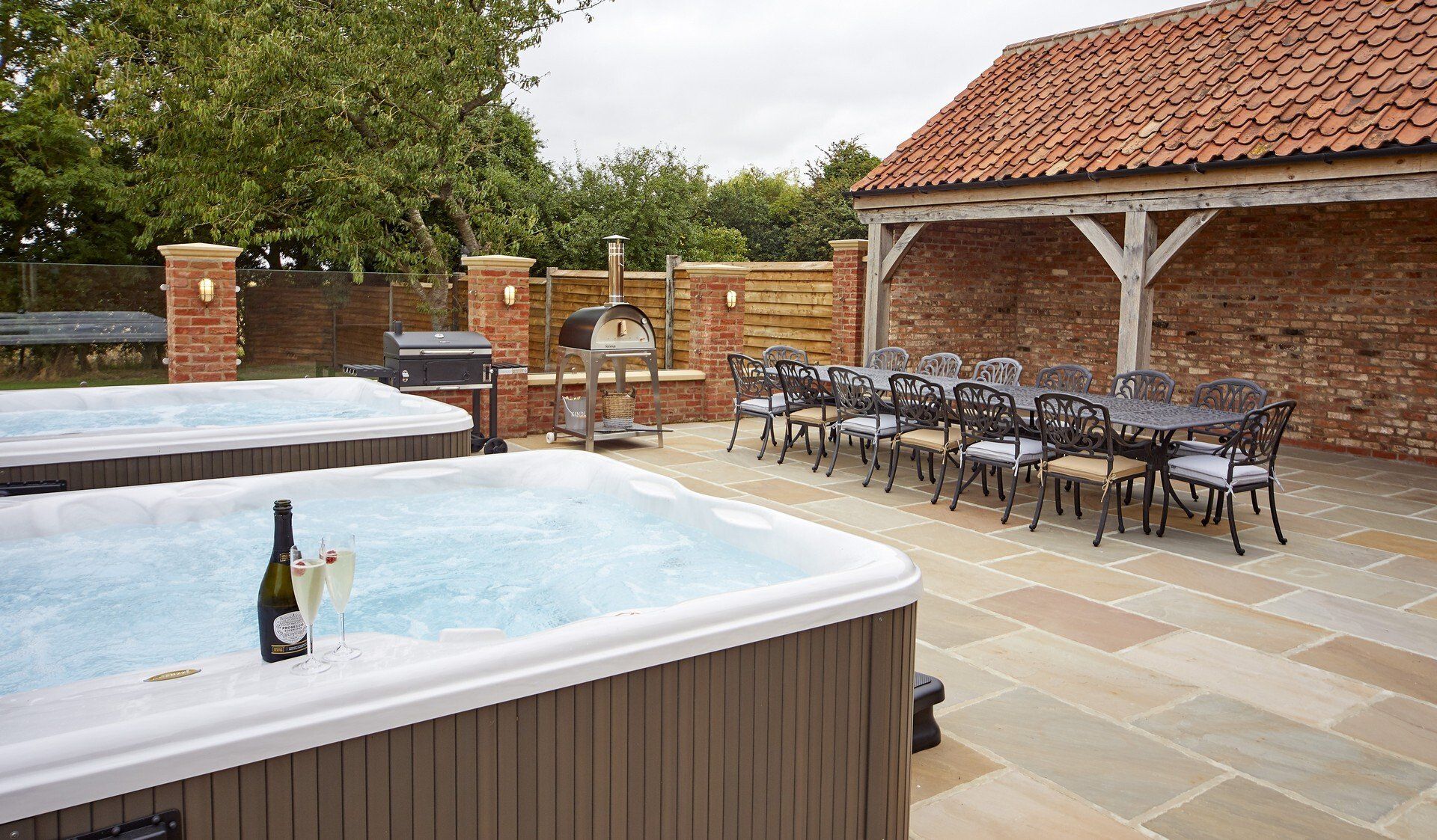 A hot tub with a bottle of champagne on top of it.