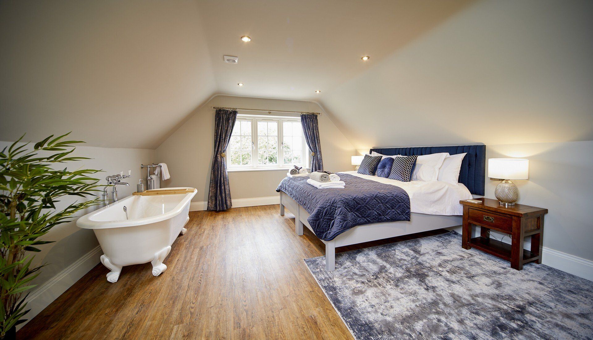Silver Birch bedroom, with slipper bath at the foot of the bed. Luxury stays suitable for all of the family