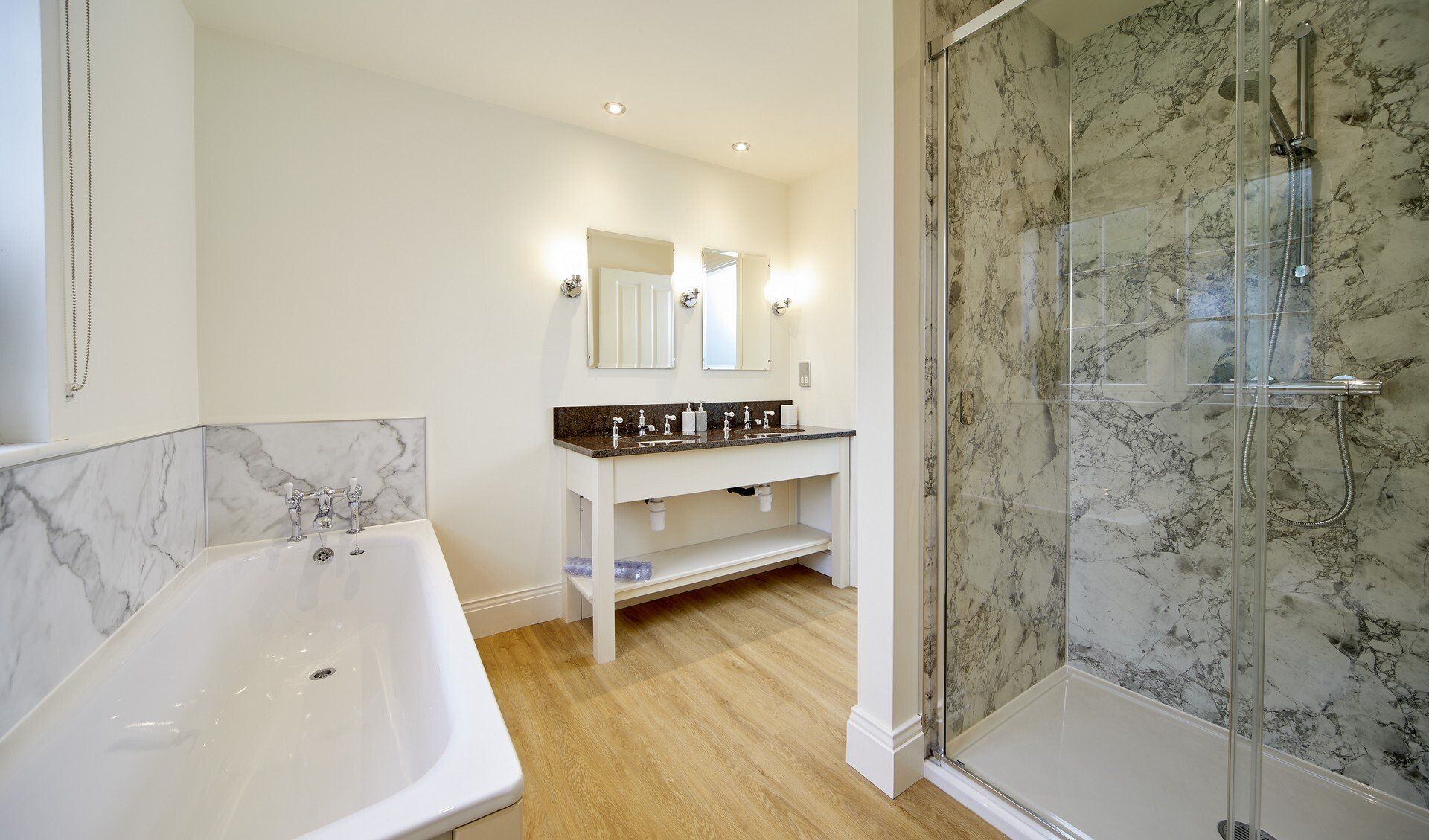 A bathroom with a tub , sink and shower.