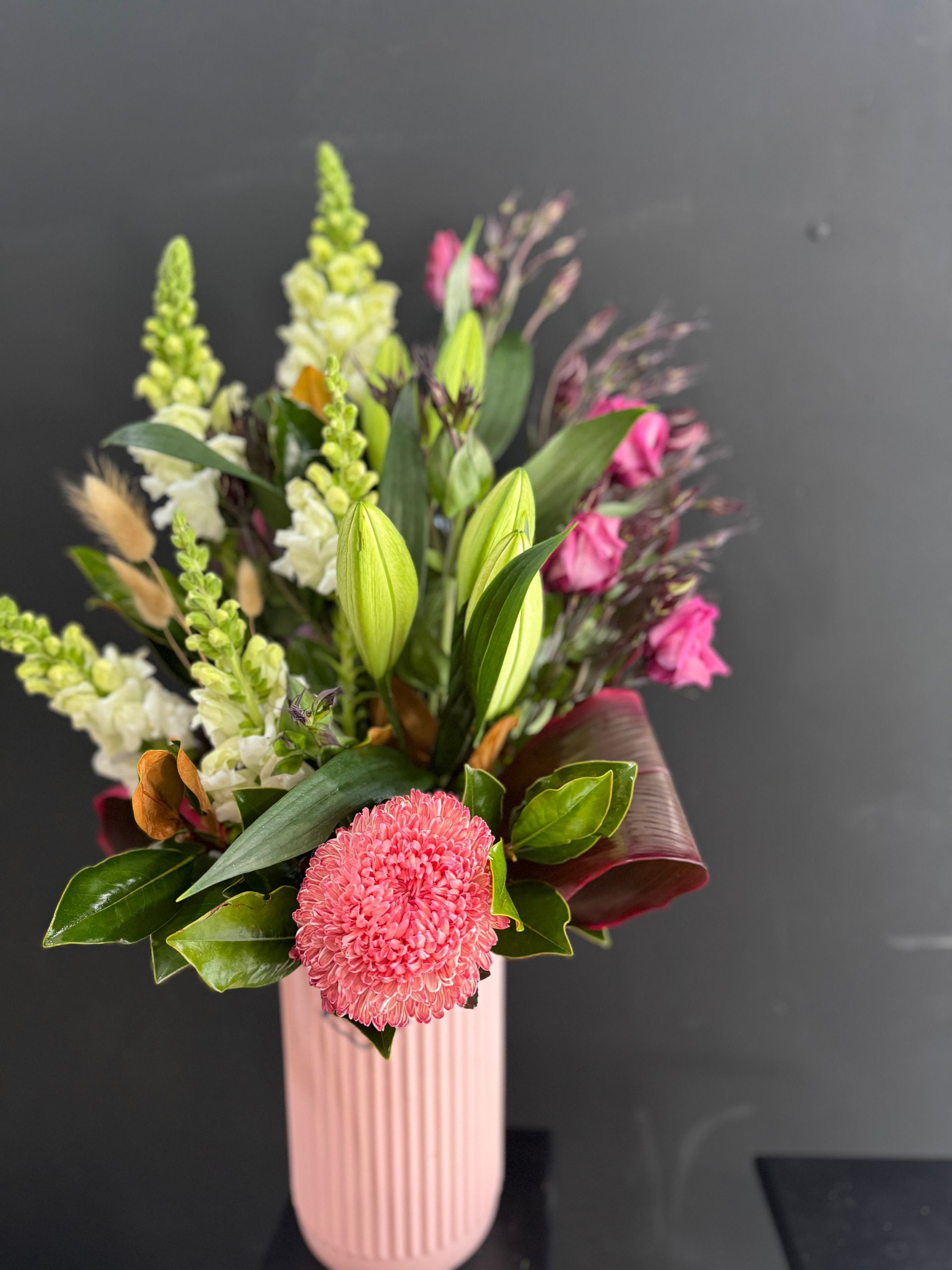 Pink Floral Arrangement in a Light Pink Vase Against a Black Background โ J'adore Flowers & Gifts Cairns in Earlville, QLD