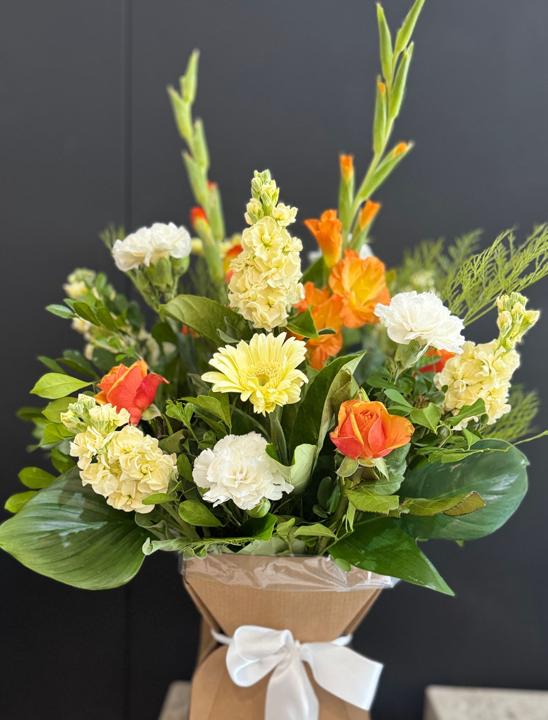 Floral Arrangement With Orange Roses and Gerbera Daisies โ J'adore Flowers & Gifts Cairns in Earlville, QLD