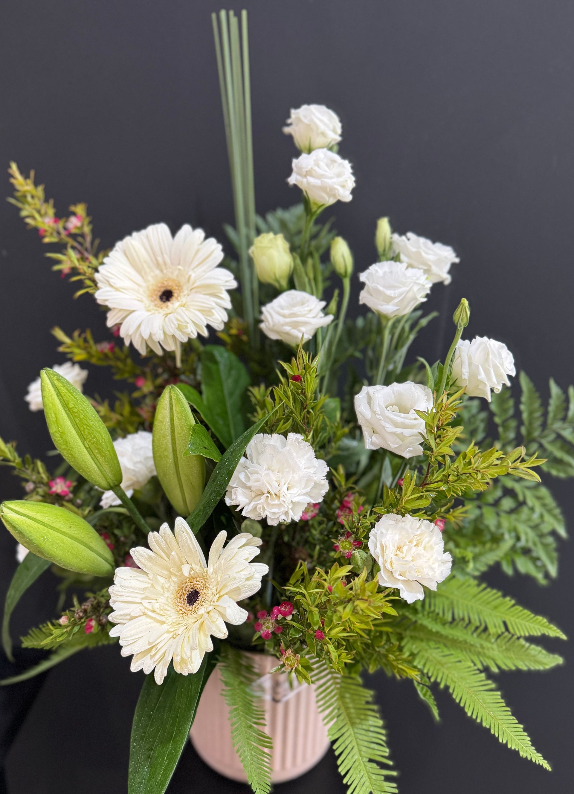 White Rose With Yellow Center Surrounded by Green Leaves โ J'adore Flowers & Gifts Cairns in Earlville, QLD