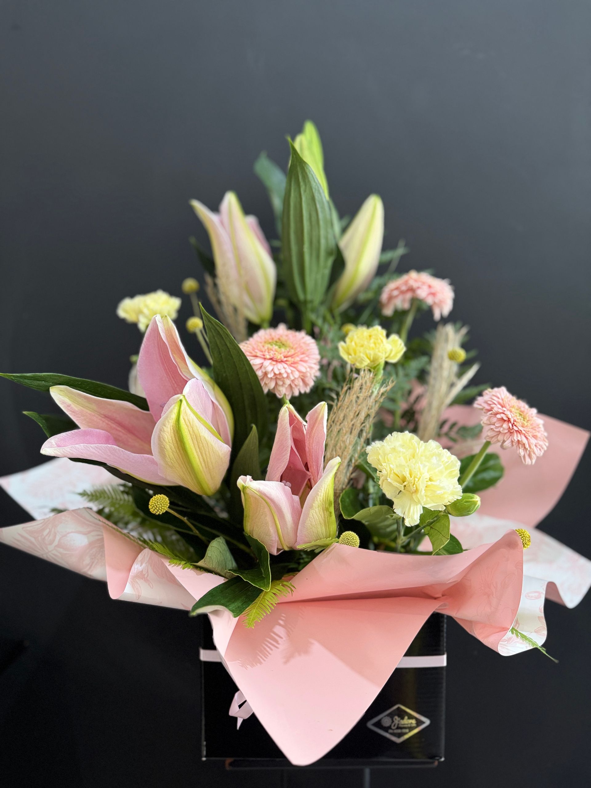 Pink Lilies and Carnations in a Black Box, Wrapped in Pink Paper โ J'adore Flowers & Gifts Cairns in Earlville, QLD