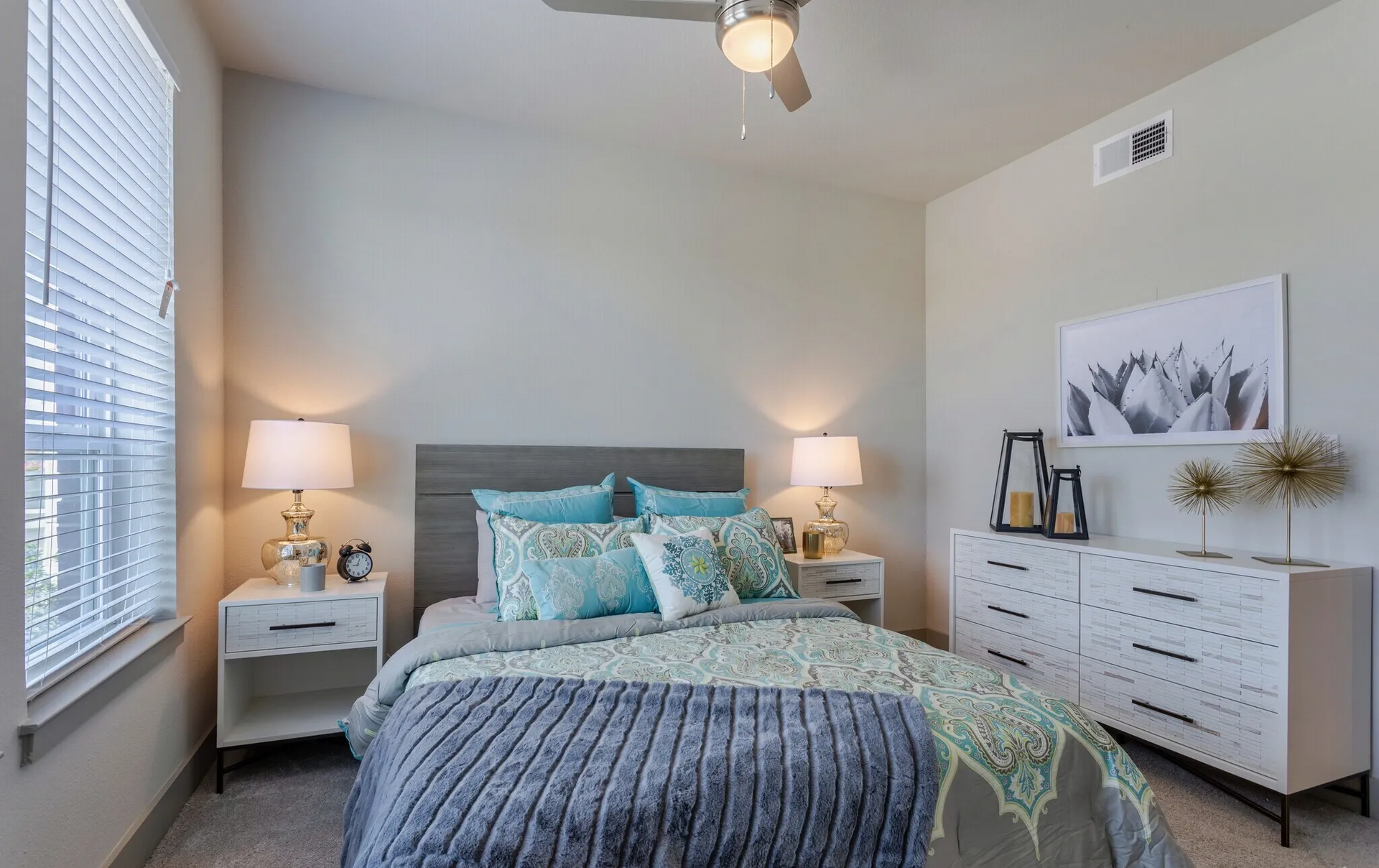 Well-furnished bedroom in a model home at Three77 Park in Fort Worth, TX.
