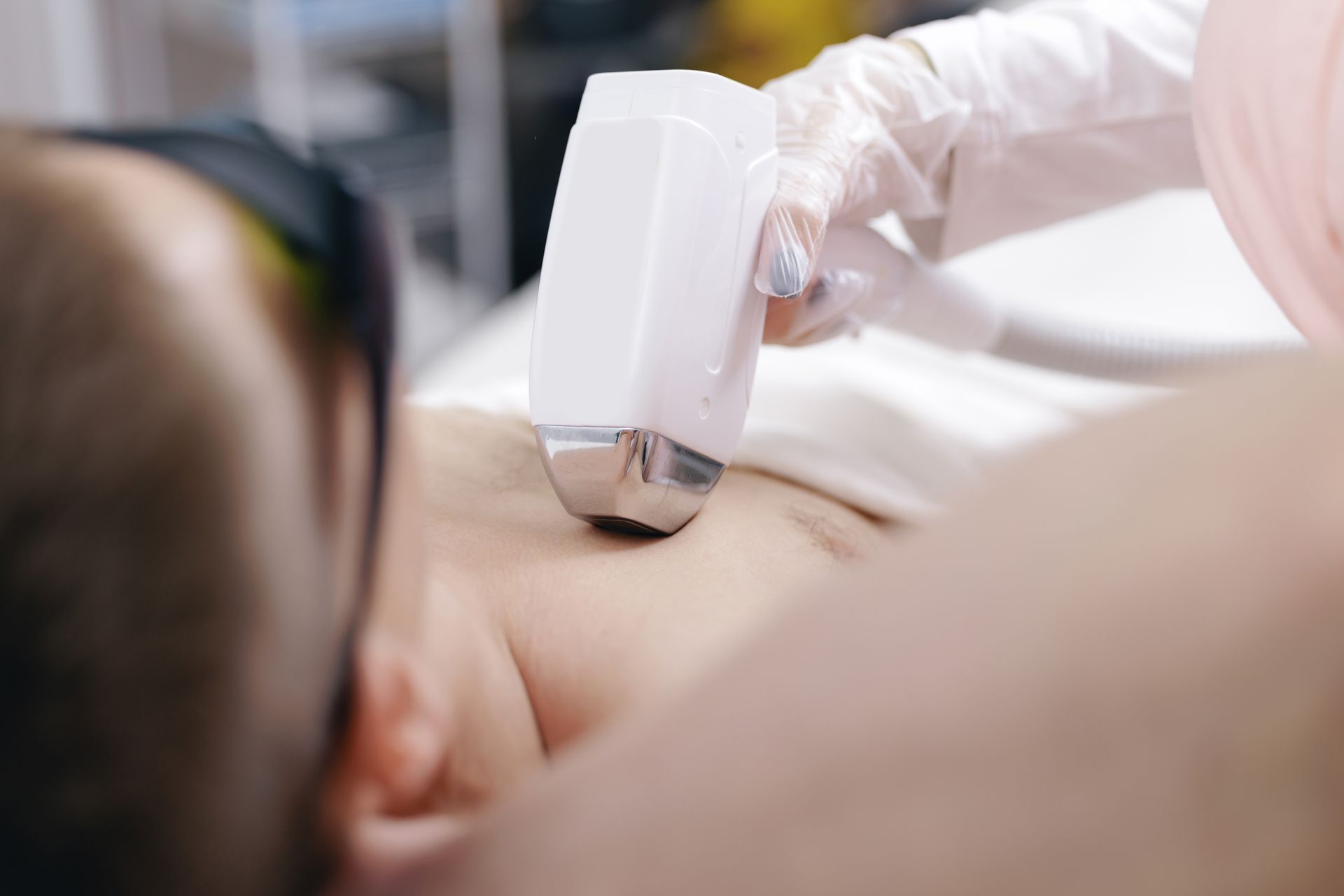 Person using a handheld device on a person’s back during a treatment session
