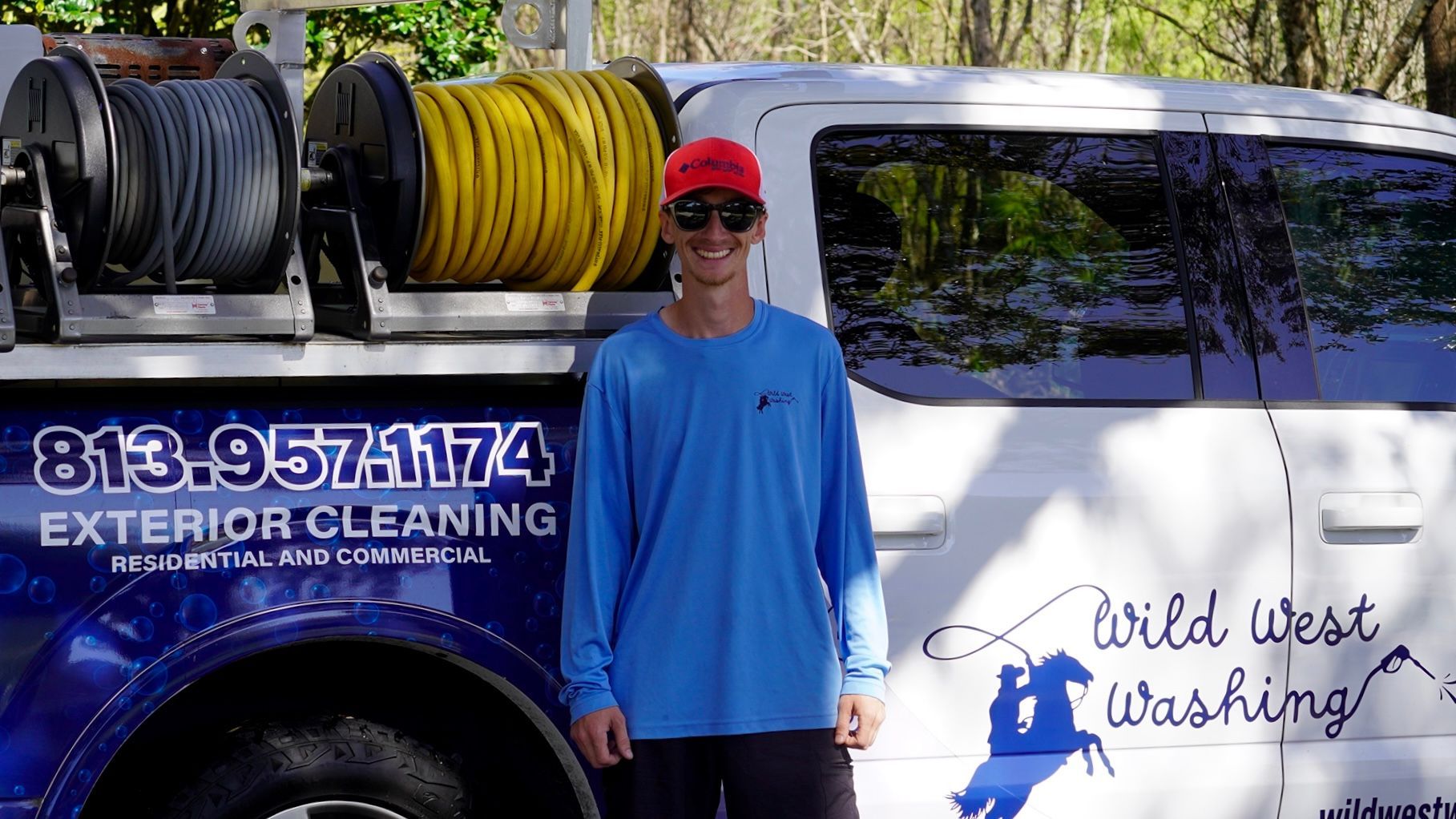 Meet Casey, proud owner of Wild West Washing, posing beside his work truck and ready to pressure wash homes across Tampa Bay.
